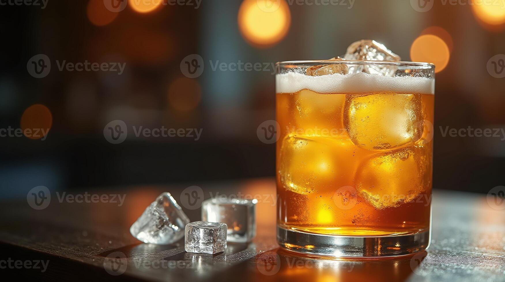 A glass of amber-colored beverage with ice cubes, set against a blurred, dimly lit background. photo
