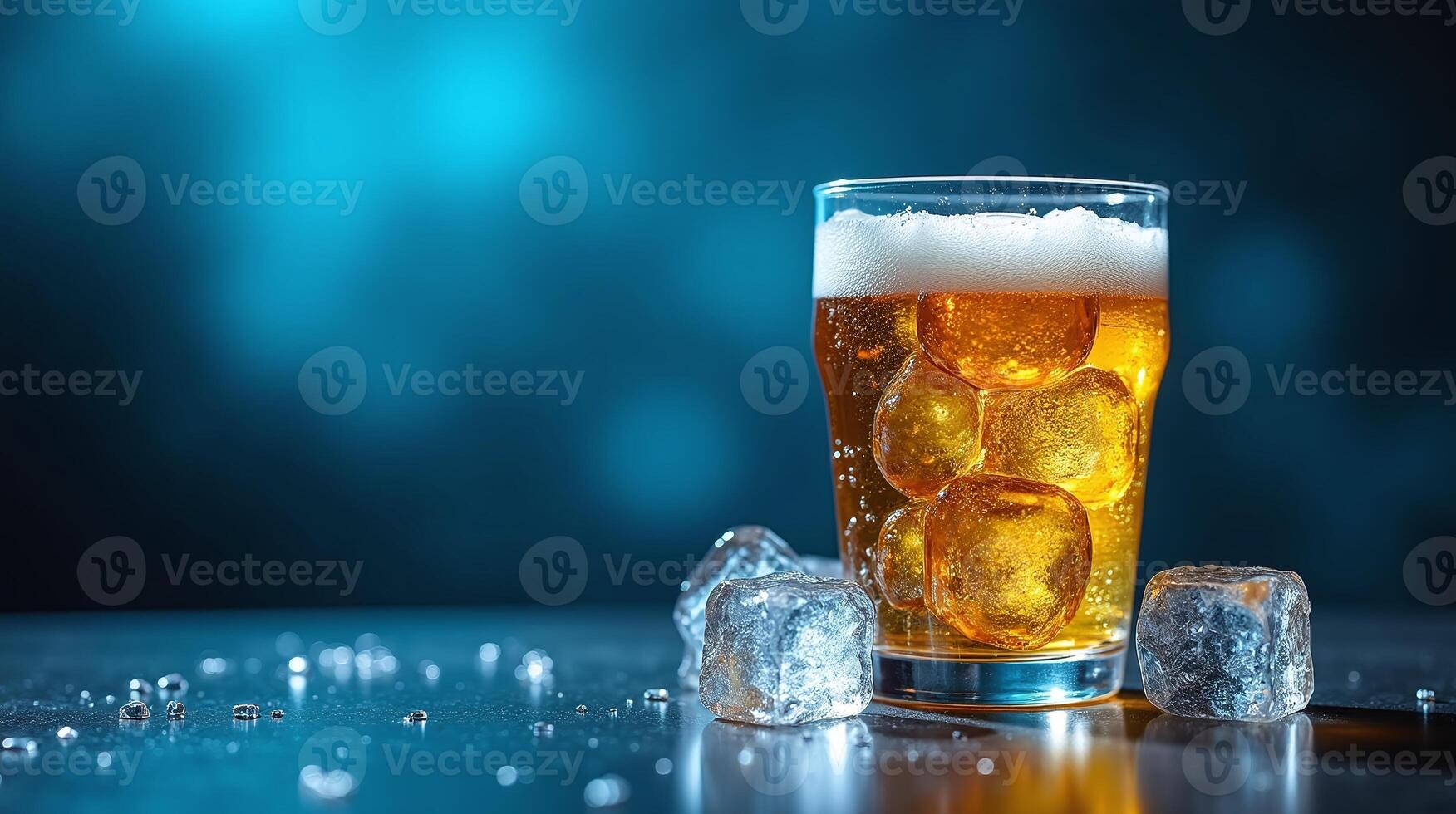 A glass of cold, frothy beer with ice cubes. photo