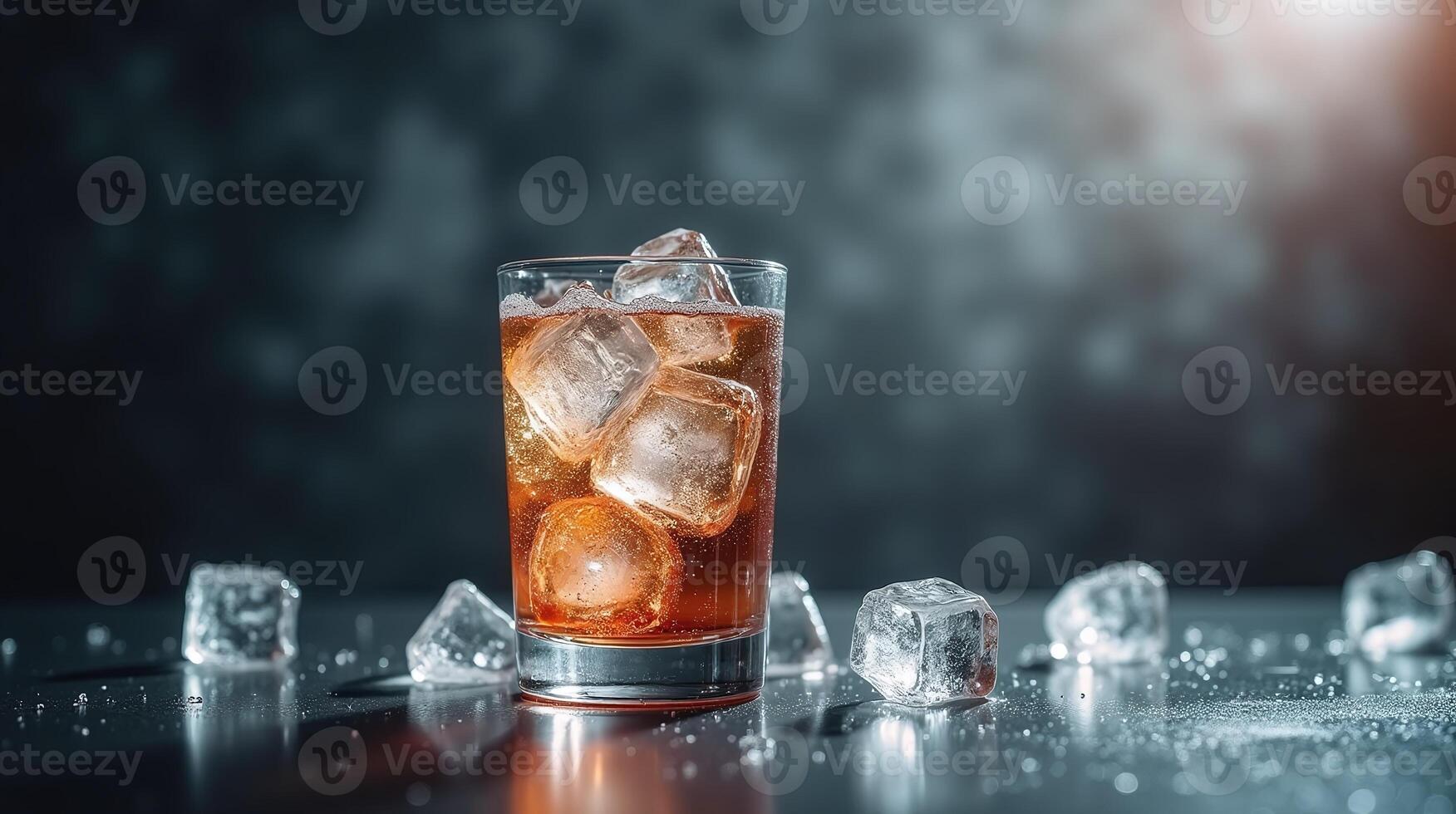 A glass filled with an amber-hued beverage, surrounded by scattered ice cubes. photo
