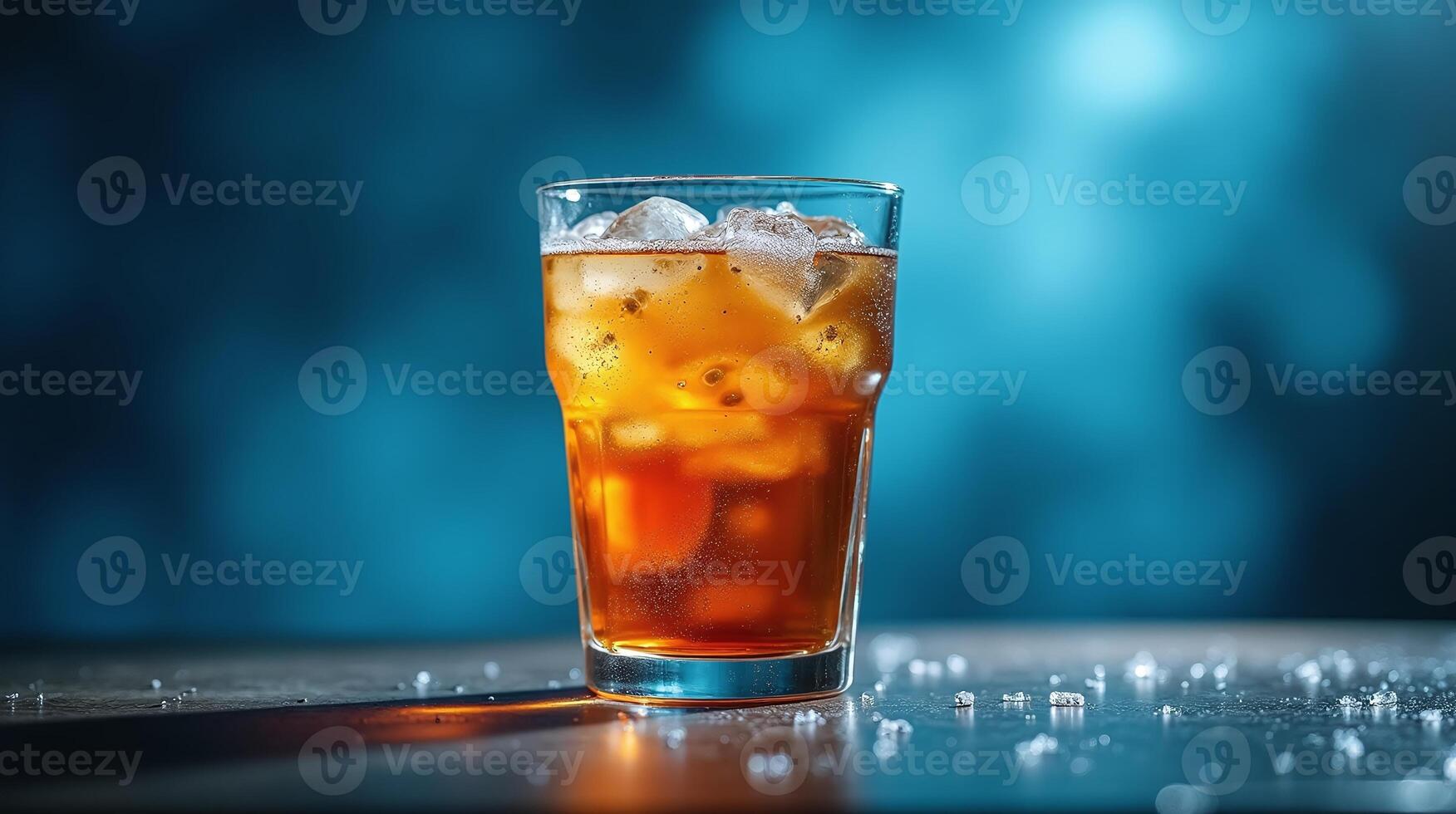 A refreshing glass of iced tea with ice cubes against a blue bokeh background. photo