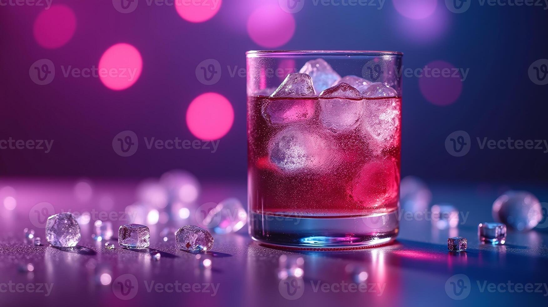 A vibrant, illuminated scene featuring a cocktail glass adorned with ice cubes against a blurred, bokeh background. photo