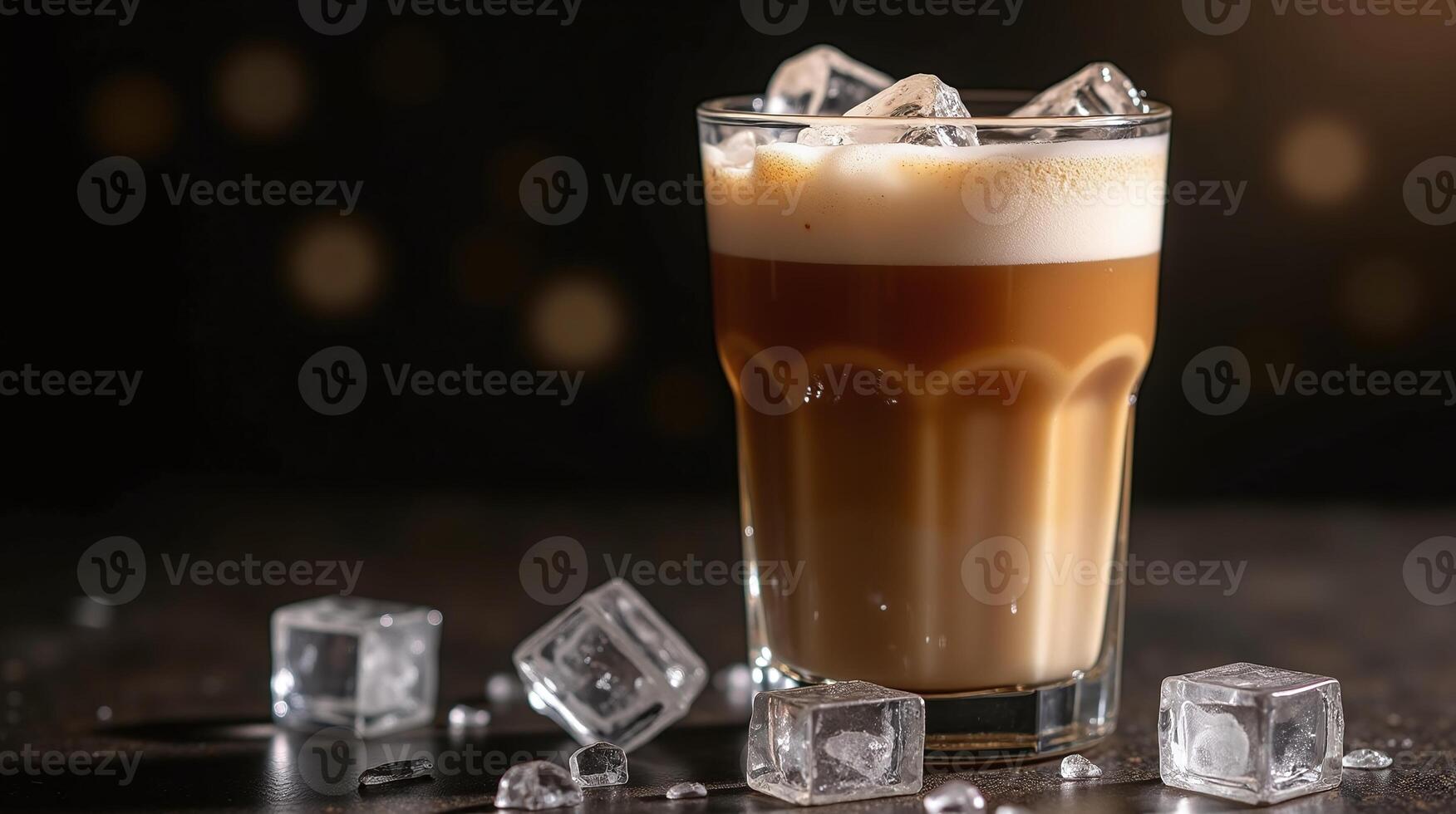 A frothy beverage with ice cubes on a dark surface. photo