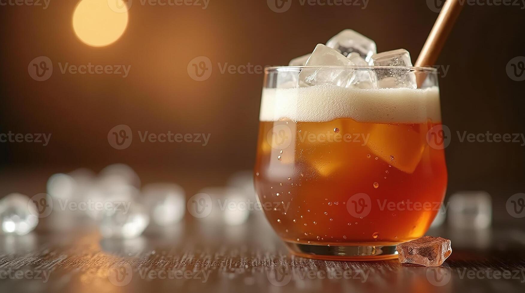 Iced beverage with frothy rim and amber hue. photo