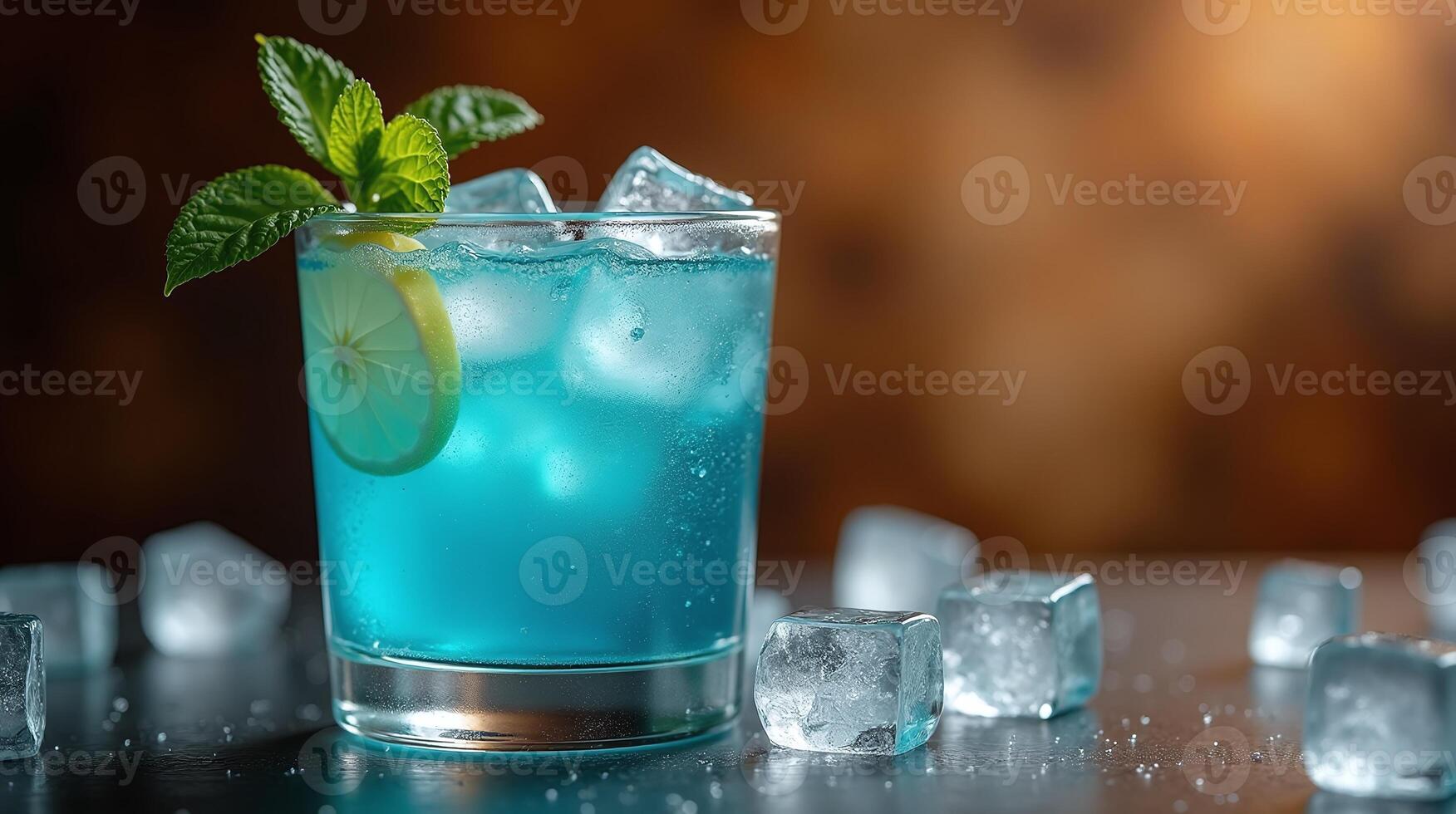 A refreshing blue cocktail garnished with mint and lemon. photo