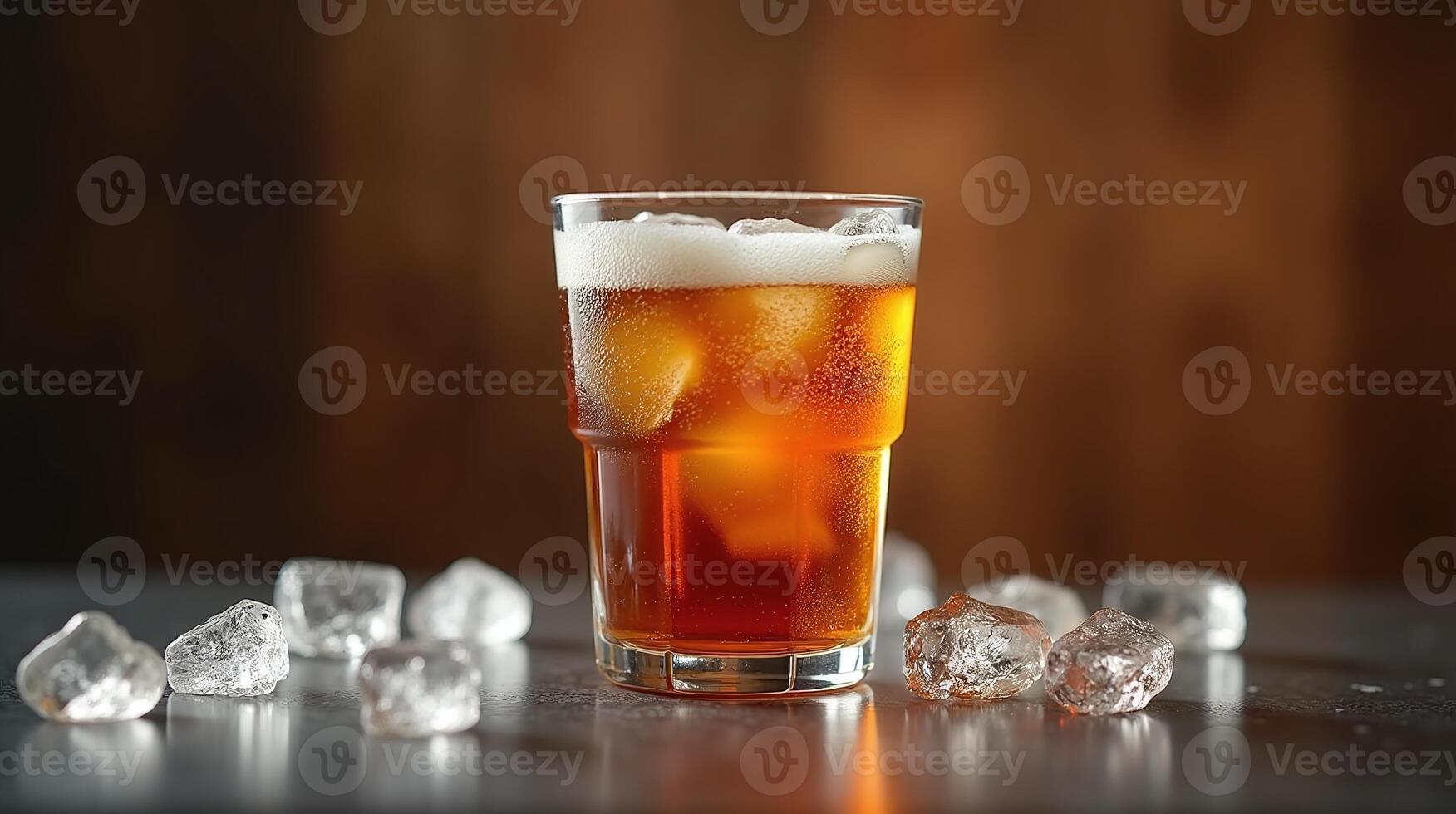 Ample, frothy beer fills a glass, accompanied by ice chunks. photo
