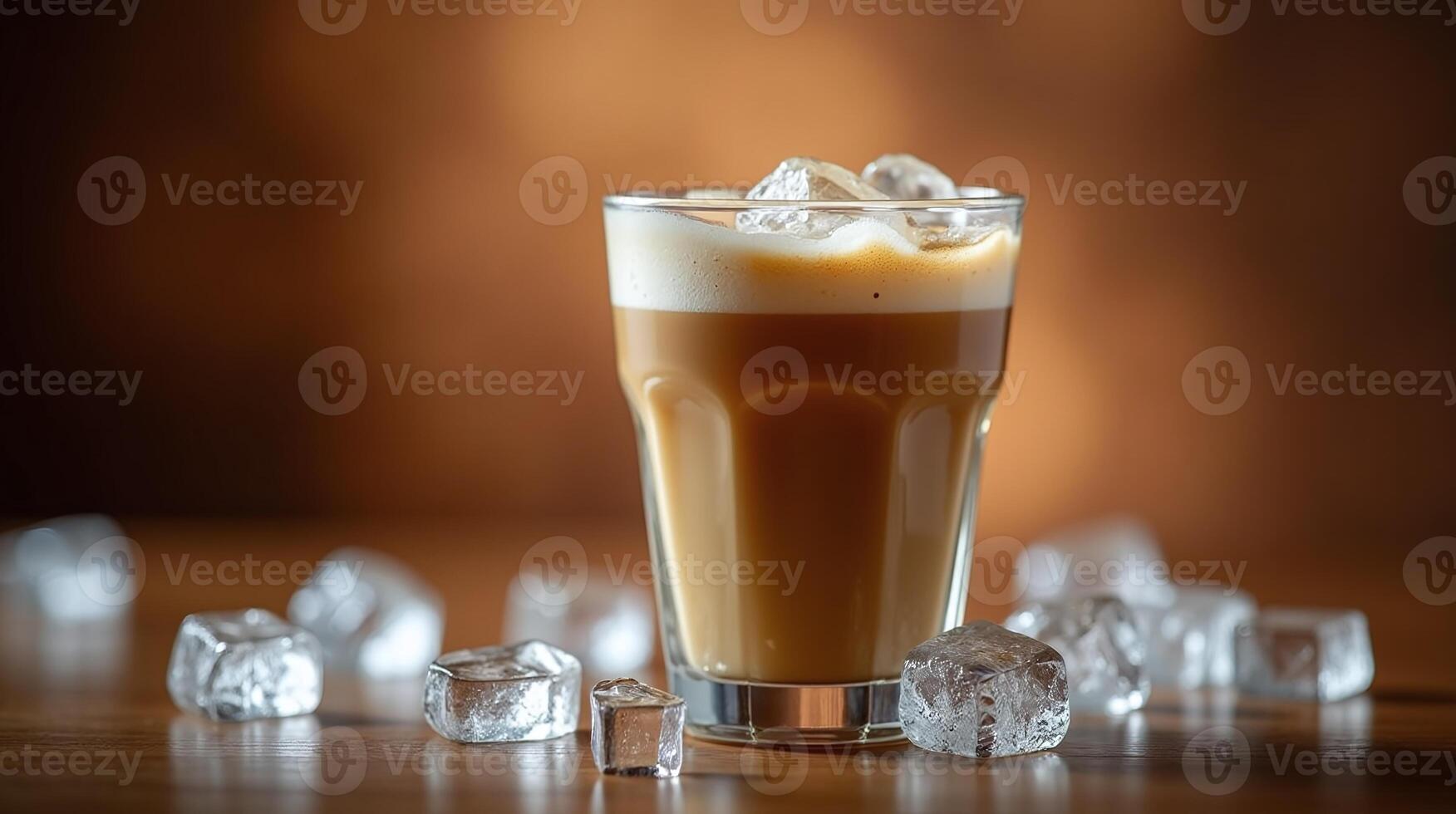 Iced coffee in a transparent glass accompanied by ice cubes on a wooden surface. photo