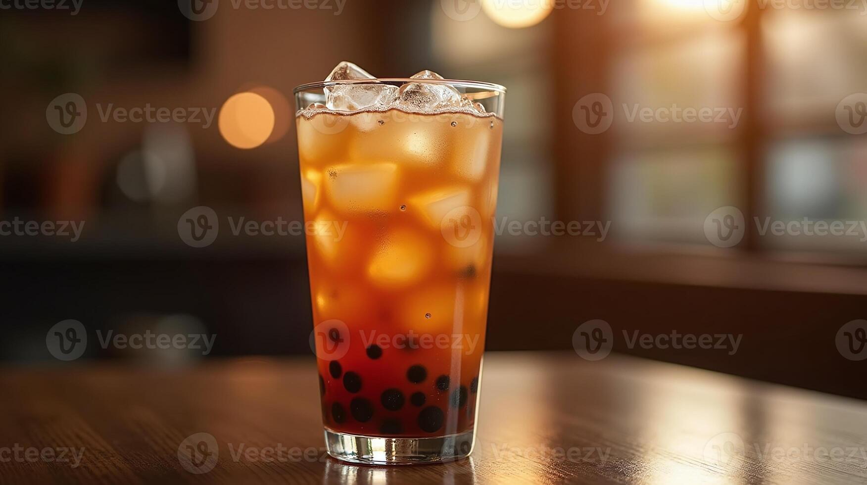 A glass of iced bubble tea on a wooden table in a cozy setting. photo