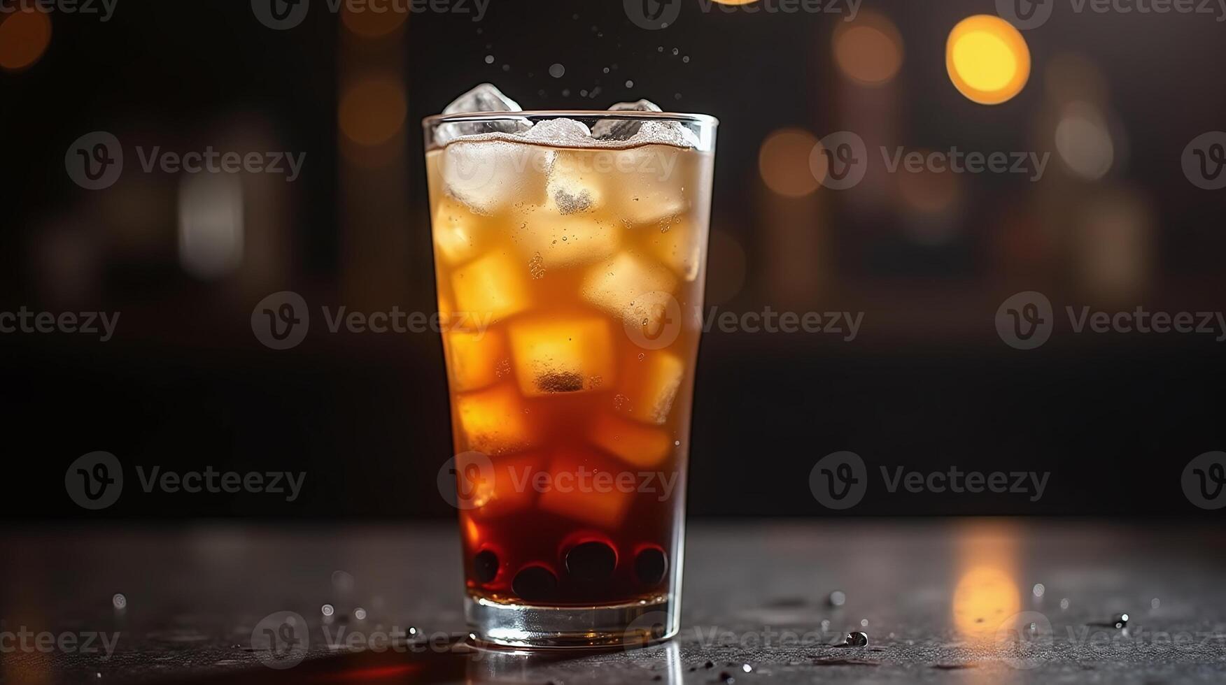 Iced beverage with ice cubes in tall glass on table. photo