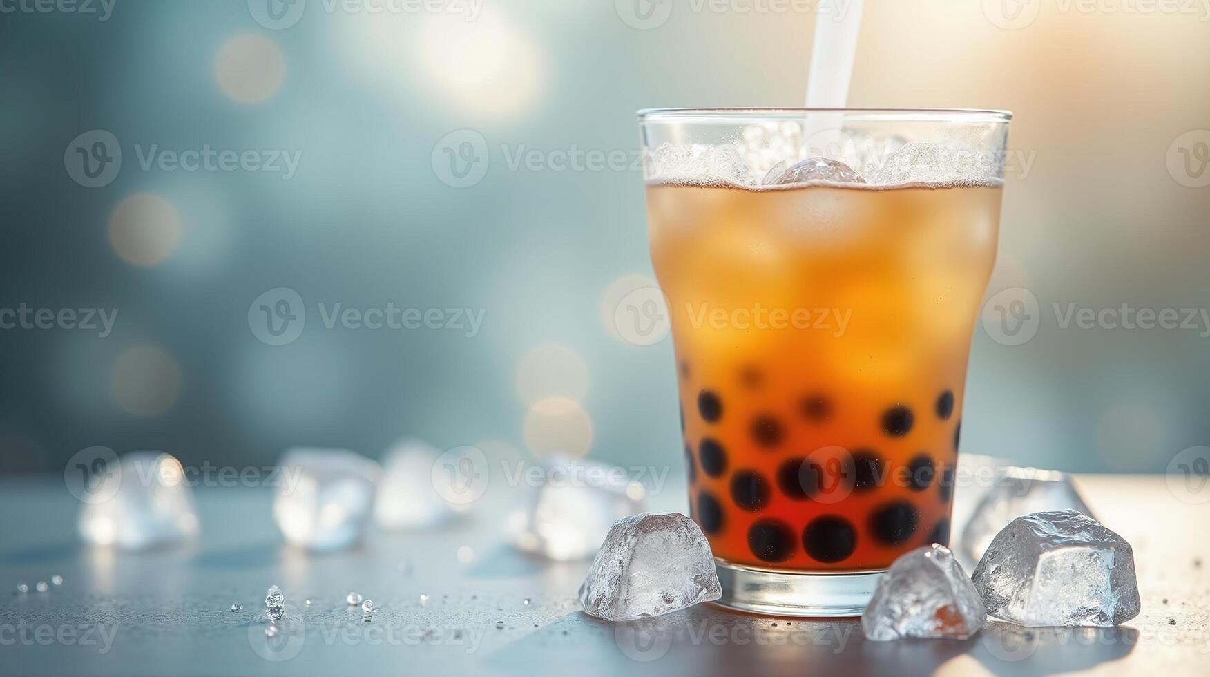 A refreshing glass of iced tea with boba pearls and ice cubes. photo