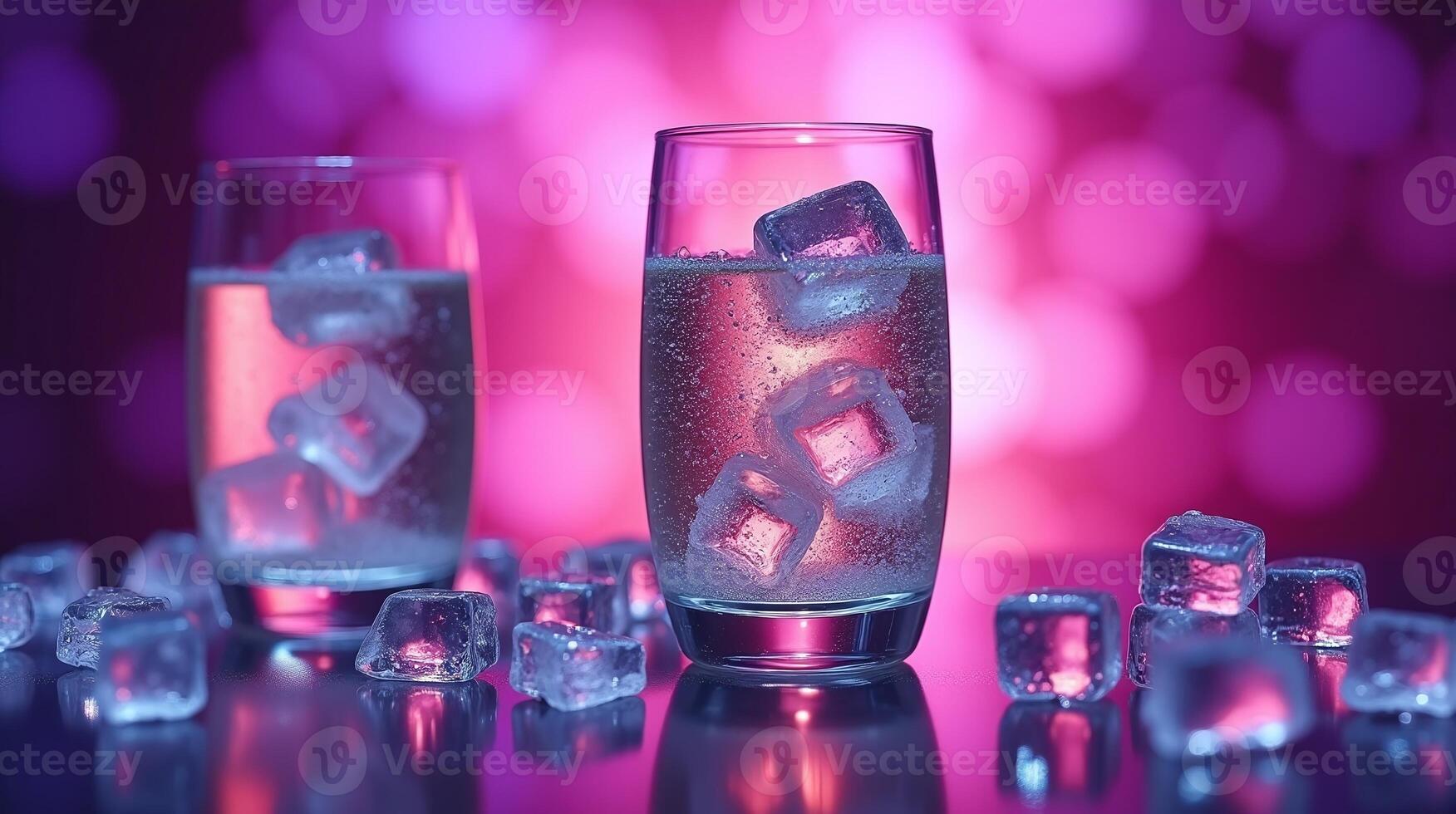 Two glasses filled with icy beverage and cubes of ice on a reflective surface against a vibrant, bokeh background. photo
