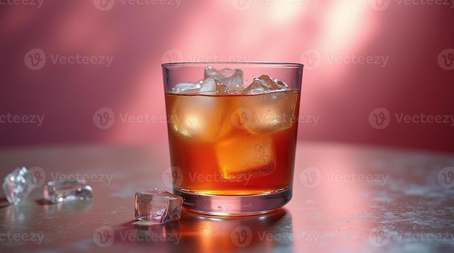 A glass of amber-colored beverage, garnished with ice cubes. photo