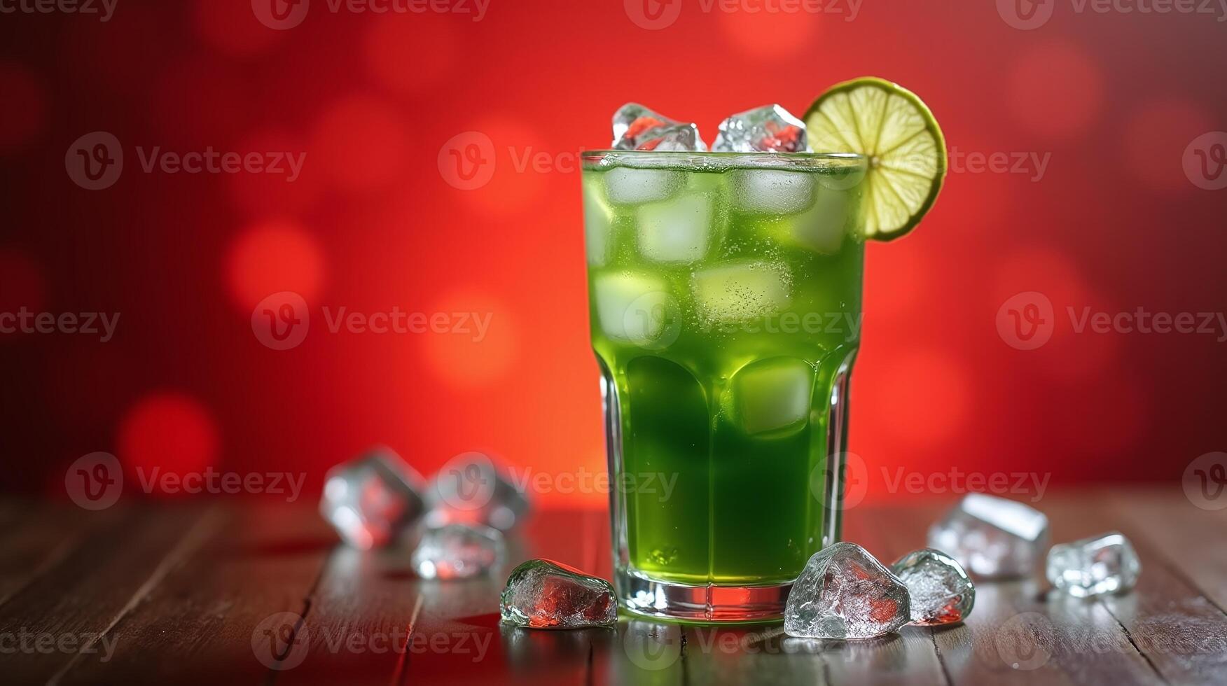 Green beverage with ice and lime slice in a glass. photo