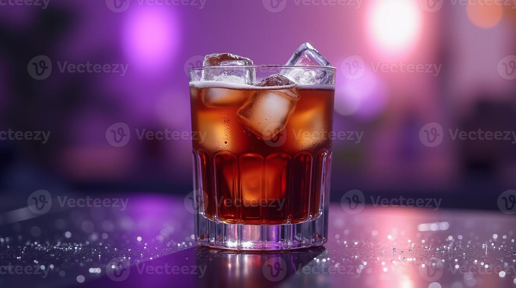 A glass filled with ice cubes and a dark liquid sits on a glittery surface, with a blurred bokeh background. photo