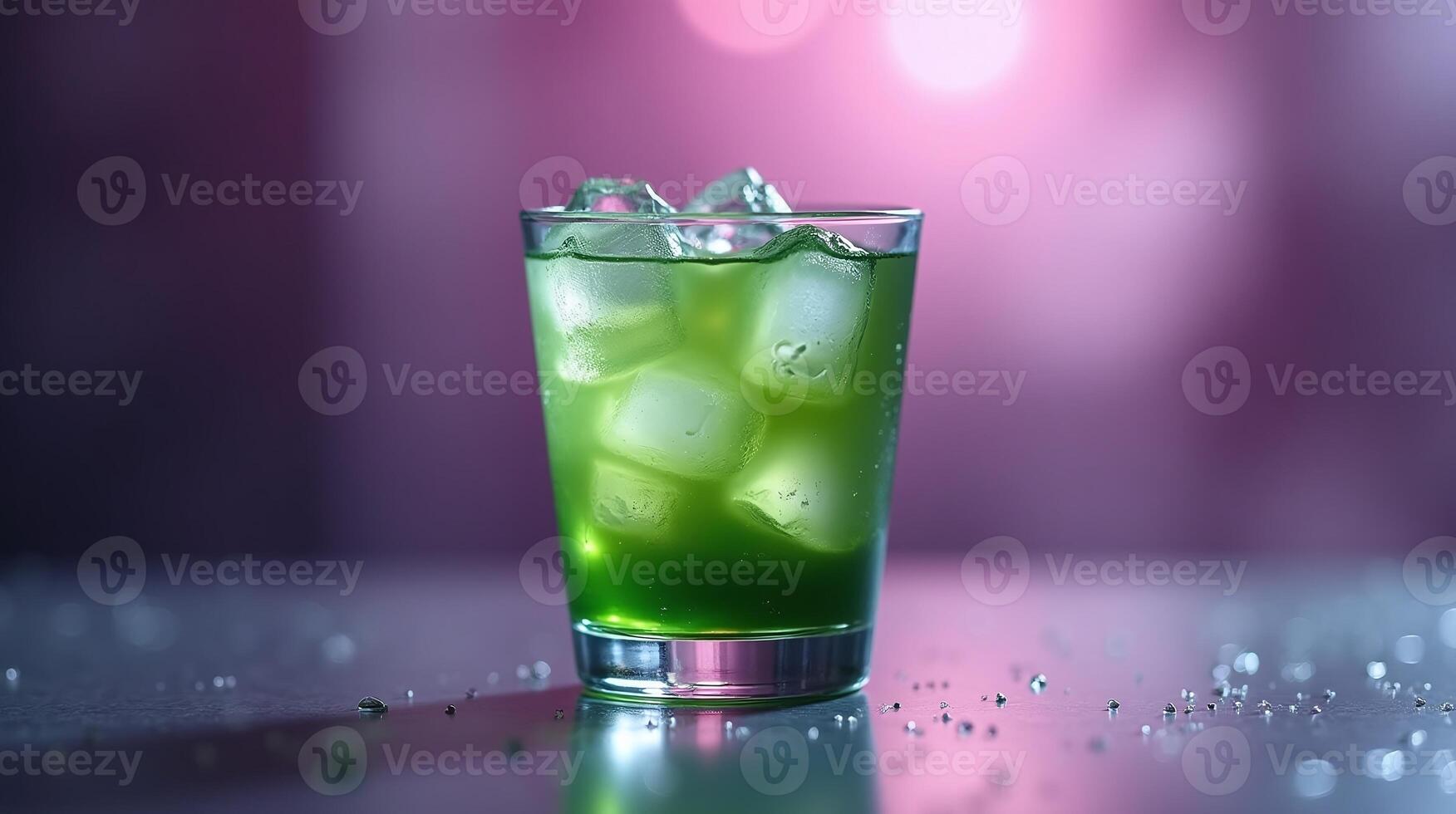 Green beverage in glass with ice cubes against blurred background. photo