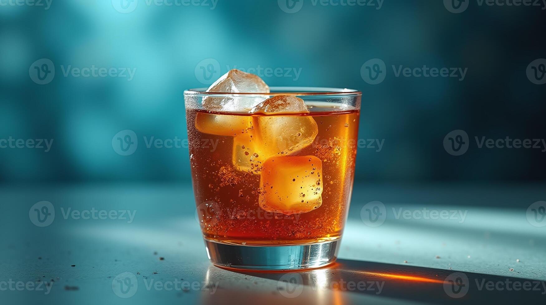 The image depicts a transparent glass filled with a reddish-brown liquid, containing three ice cubes and a few bubbles, set against a blue background. photo