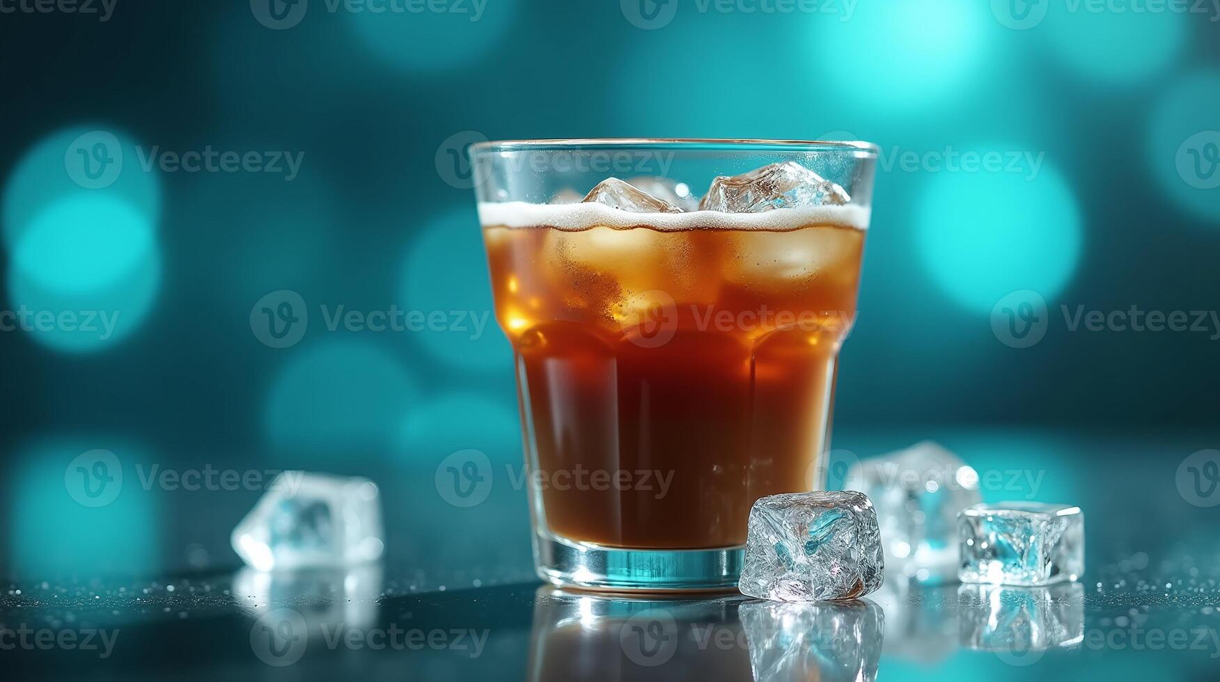 A glass of iced coffee with frothy foam rests on a reflective surface, surrounded by scattered ice cubes against a blurred bokeh backdrop. photo