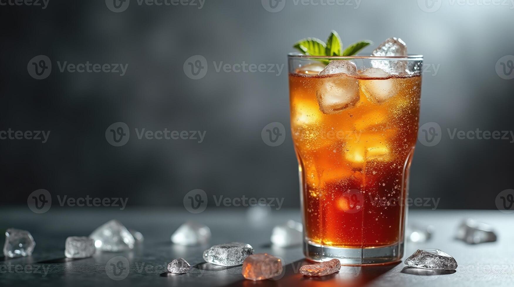 A refreshing beverage with ice cubes and a green leaf garnish. photo