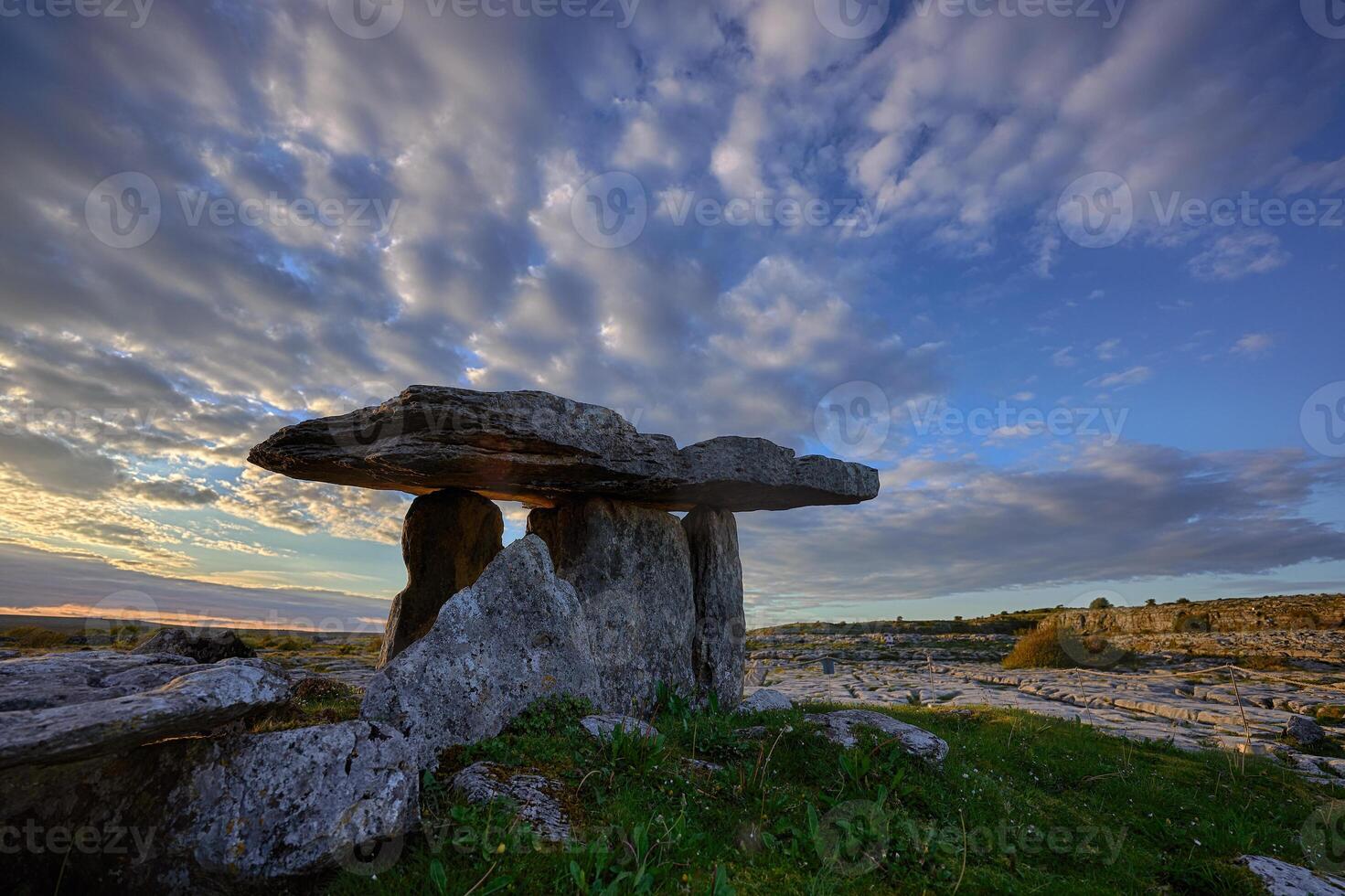 Sunset over Poulnabrone dolmen an ancient portal tomb in the Burren, County Clare, in the west Ireland photo