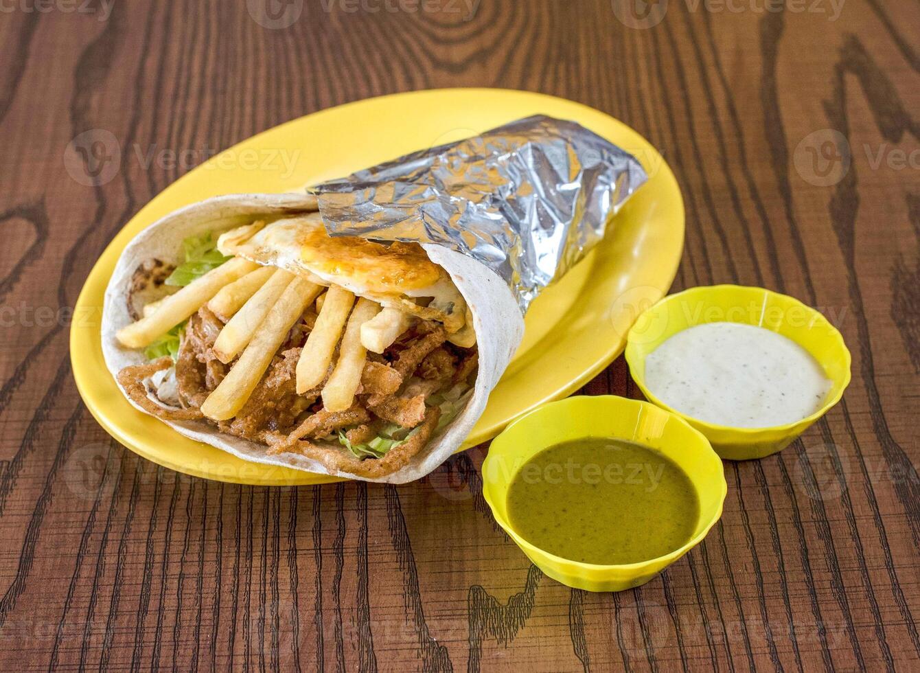Delicious Beef Shawarma Wrap with Crispy Fries and a Fried Egg photo