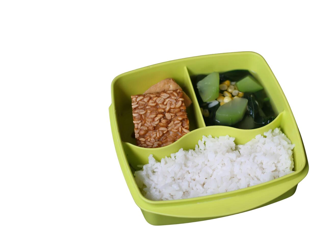 Balanced nutritious food consisting rice, egg, tofu, tempeh, and vegetables, served on green lunch box, suitable for students health photo
