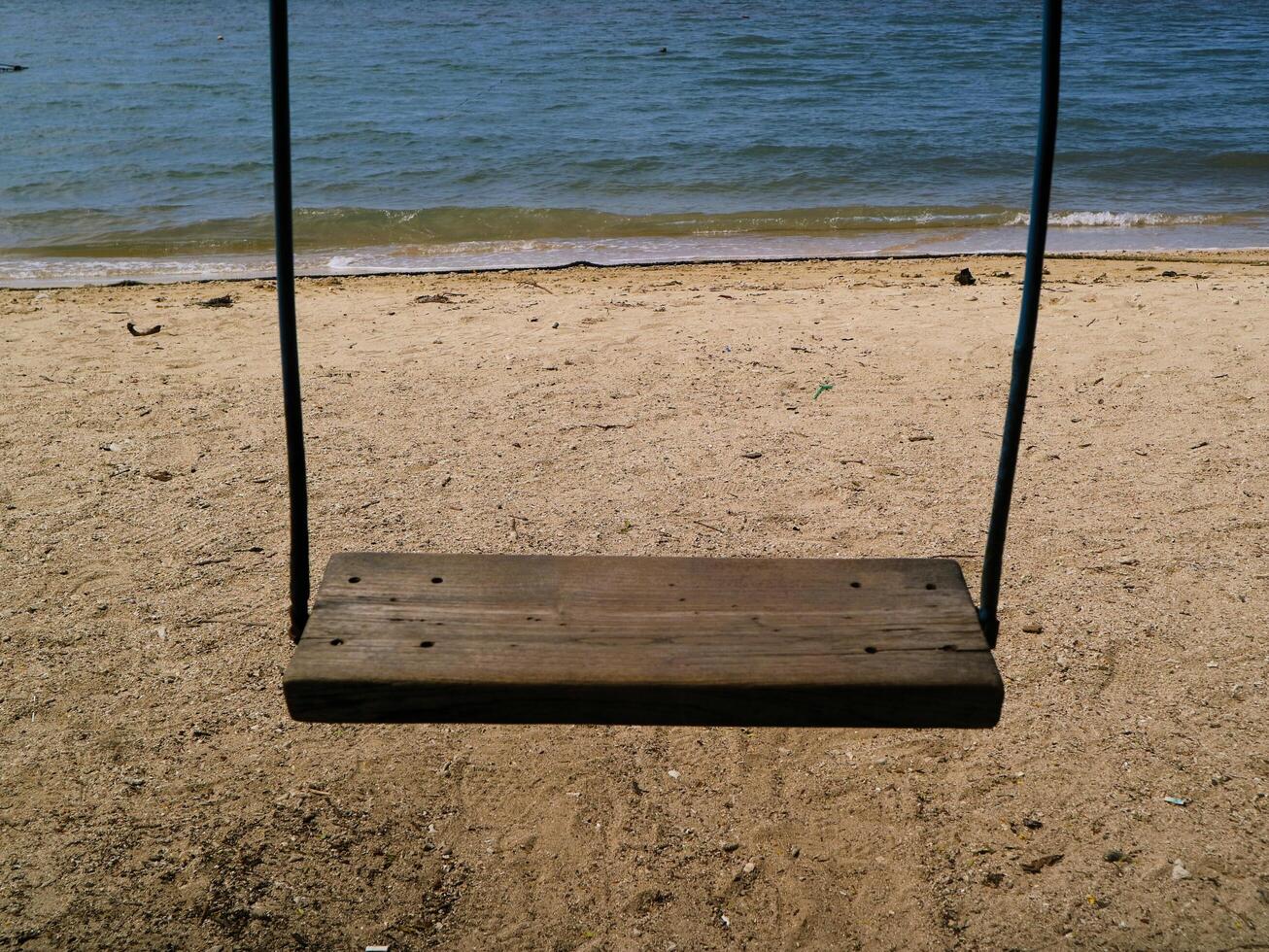 Wooden swing with and and blue sea background, suitable for product such as health, lifestyle, relaxation, fresh drinks, frozen desserts, and leisure photo