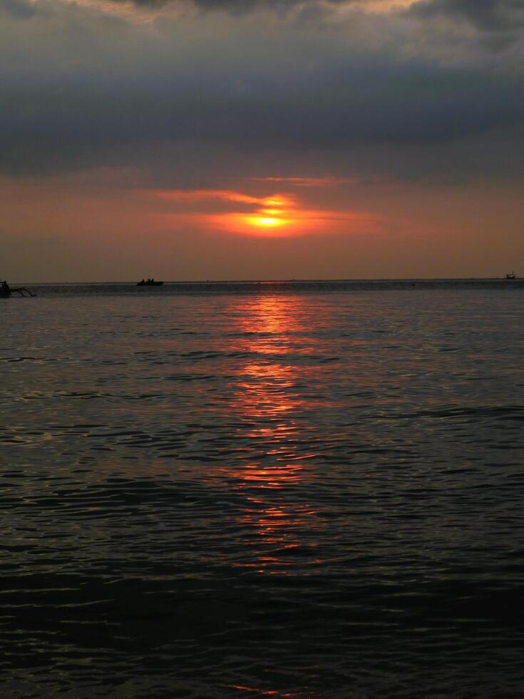 Panoramic sunset view at a luxury beach in the tropics, Serene sunset over calm ocean, photo