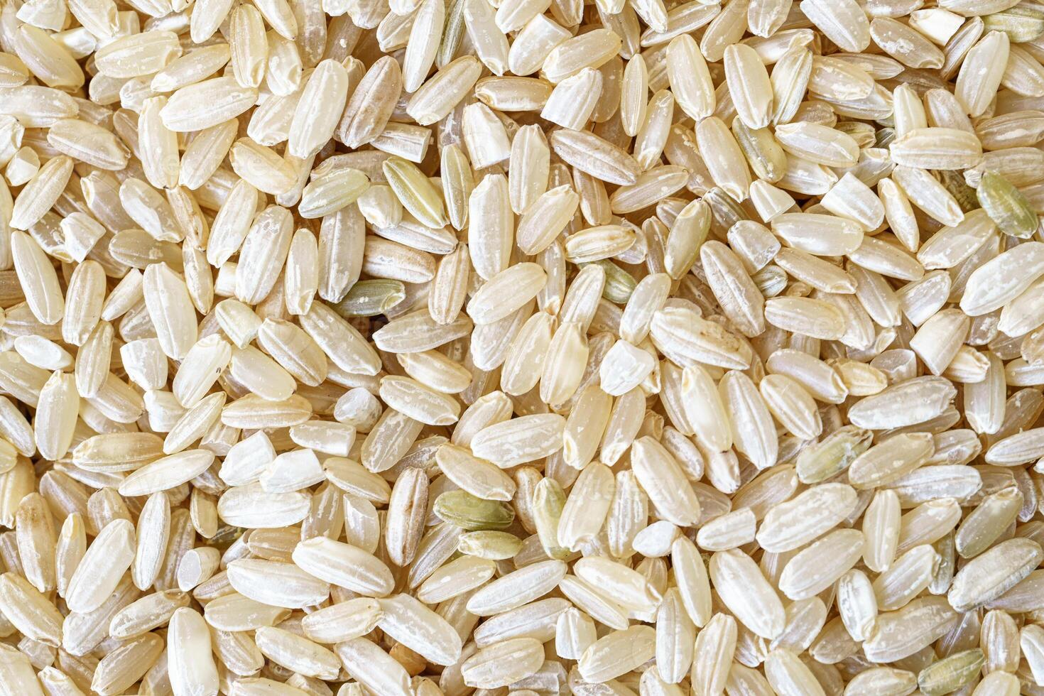 Macro shoot of flat lay texture of brown rice for food and nutrition background healthy eating and cooking concept with copy space pattern of organic grains. photo