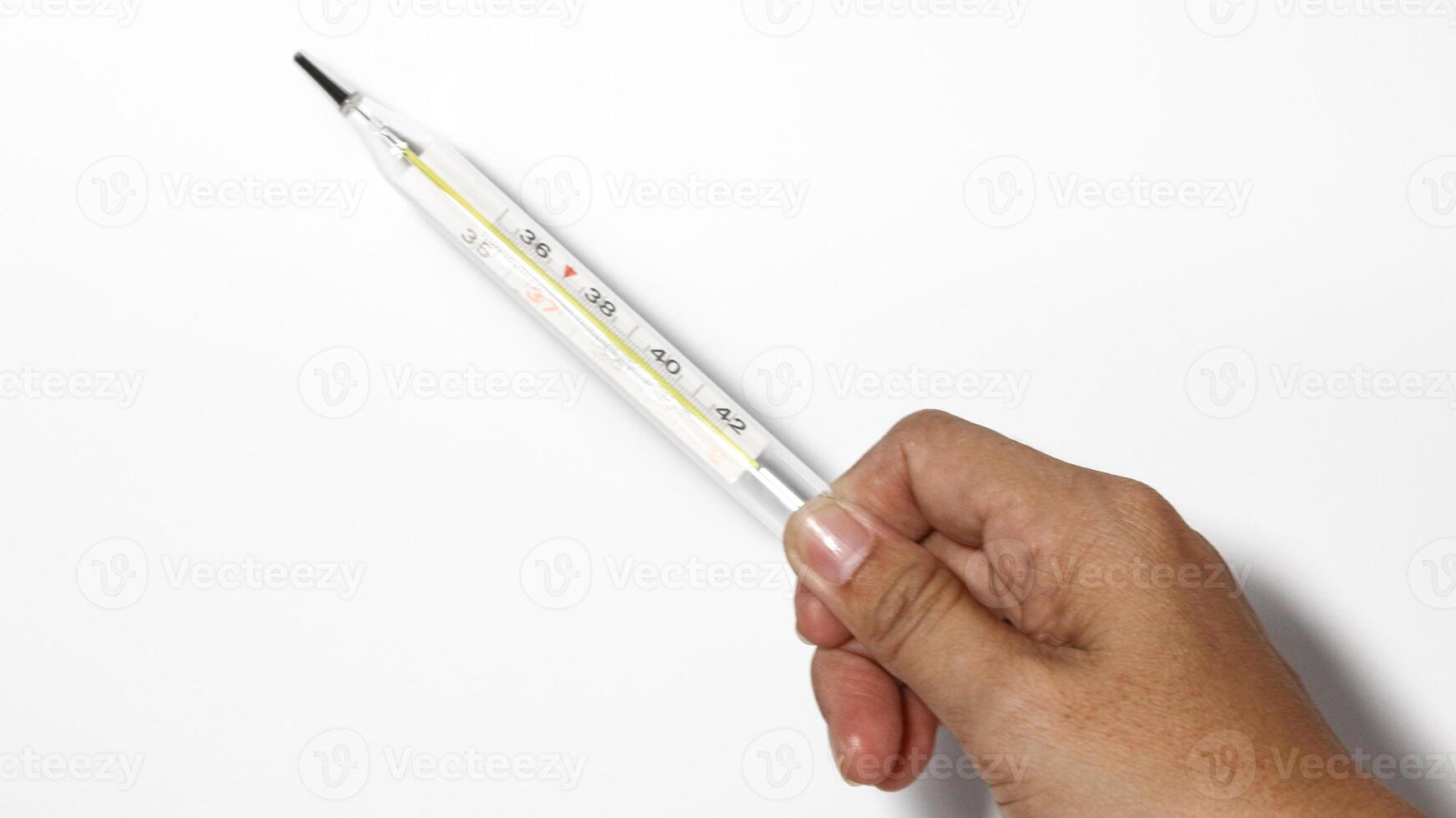 Close-up shot of clinical thermometer on white surface, photo