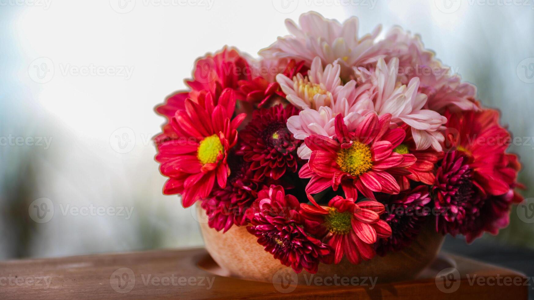 one basket of red, pink, yellow and purple daisies nature background. Asters are a genus of perennial flowering plants in the Asteraceae family, photo