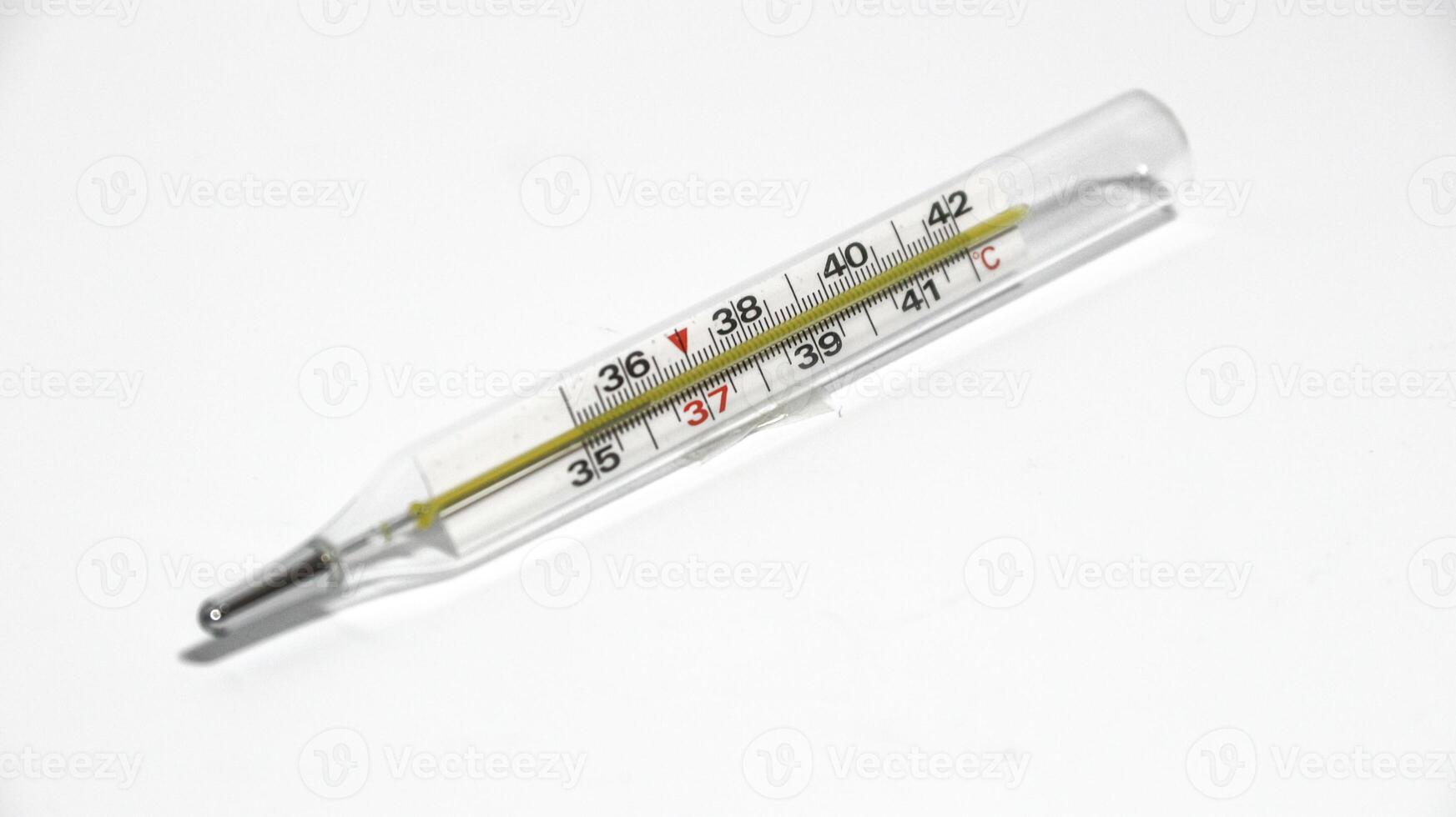 Close-up shot of clinical thermometer on white surface photo