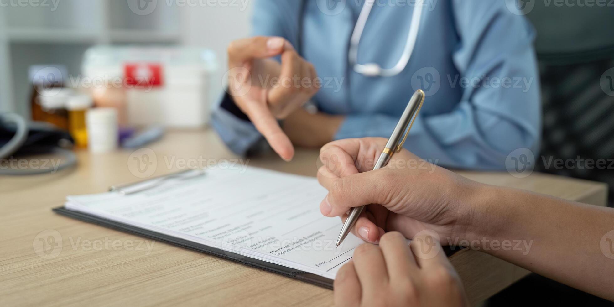 Patient Documentation. Patient signing forms during a healthcare consultation. photo
