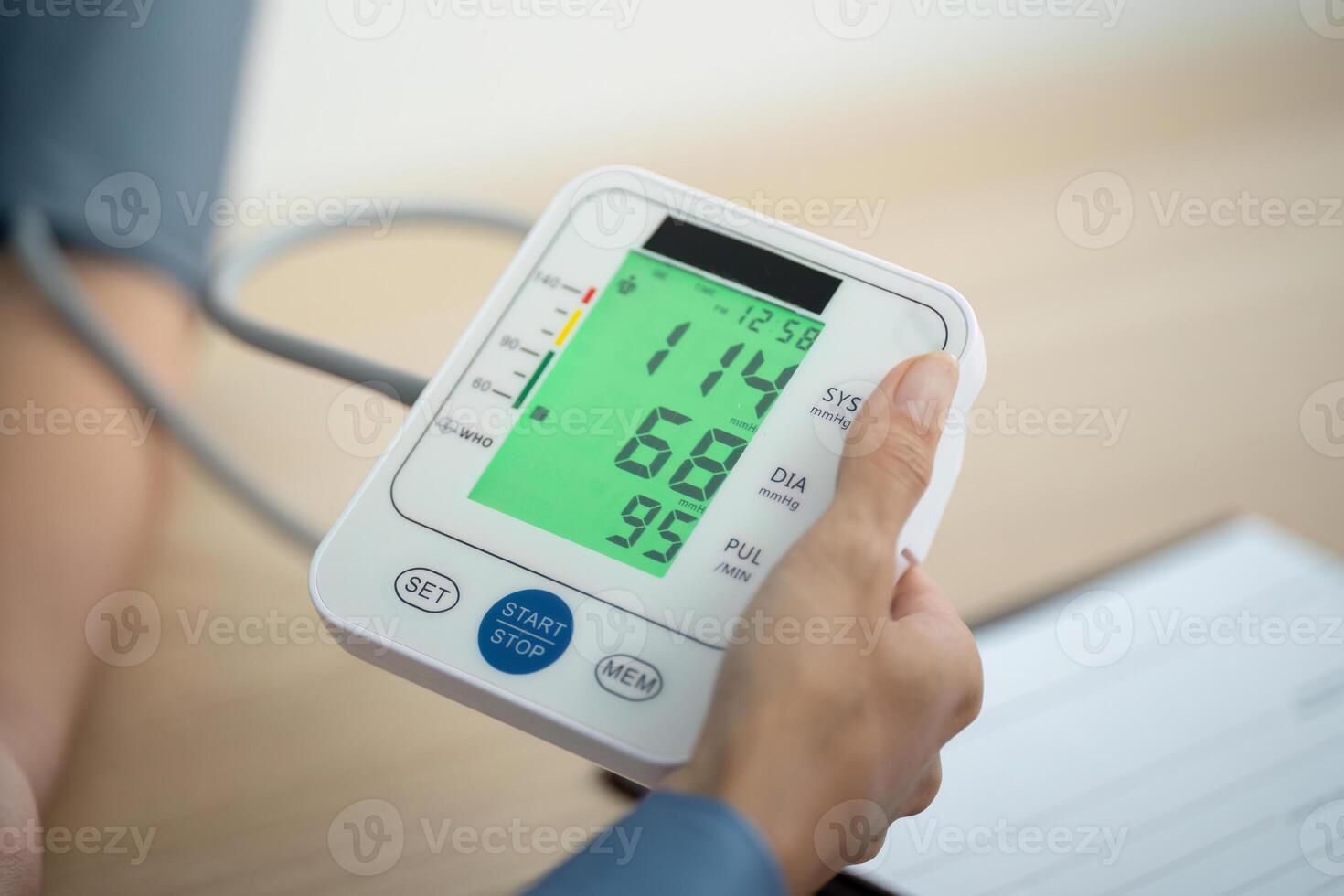 Blood Pressure Measurement. Nurse showing results from digital monitor to patient. photo