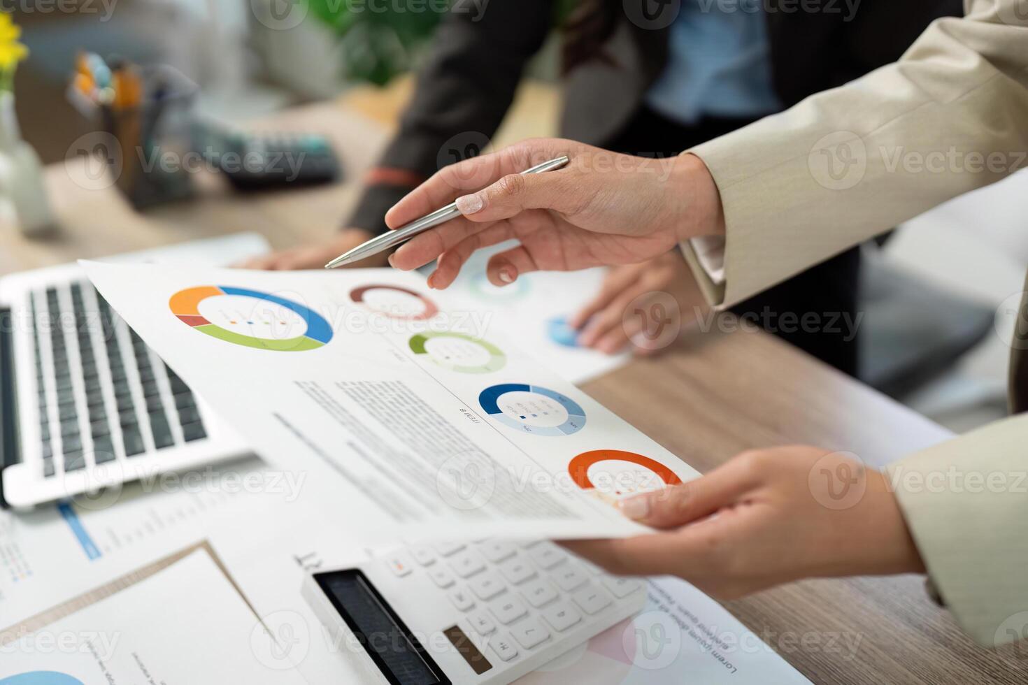 Data Analysis and Report Review. Professionals discussing visual data in a meeting. photo