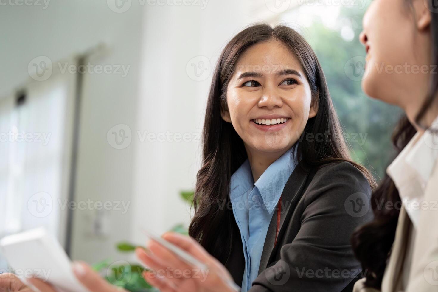 Positive Interaction and Teamwork. Smiling businesswoman engaging in conversation with colleague. photo