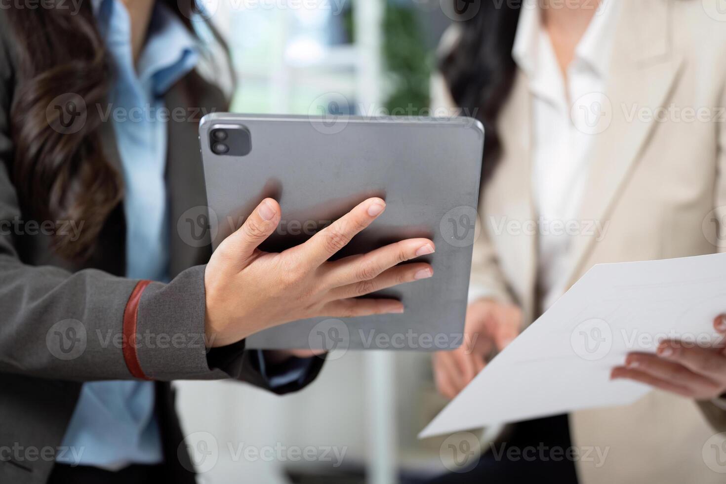 Digital Transformation in Business. Professionals reviewing data on a tablet during a meeting. photo