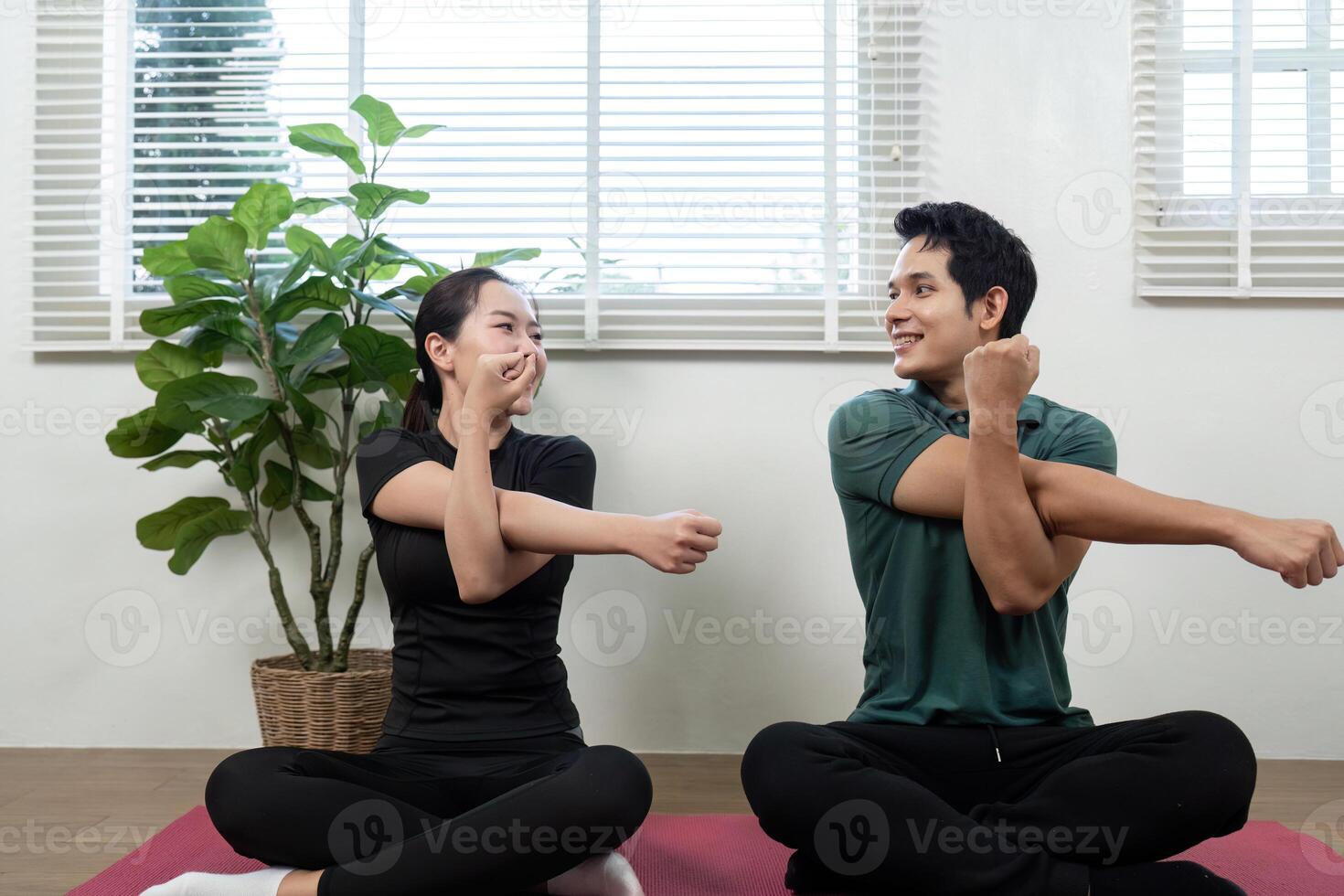 Wellness and Couple. Partners smiling while performing stretching exercises together indoors. photo