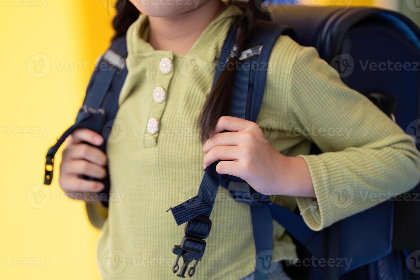 Back to School. Close-up of a child adjusting their backpack for a new school year. photo