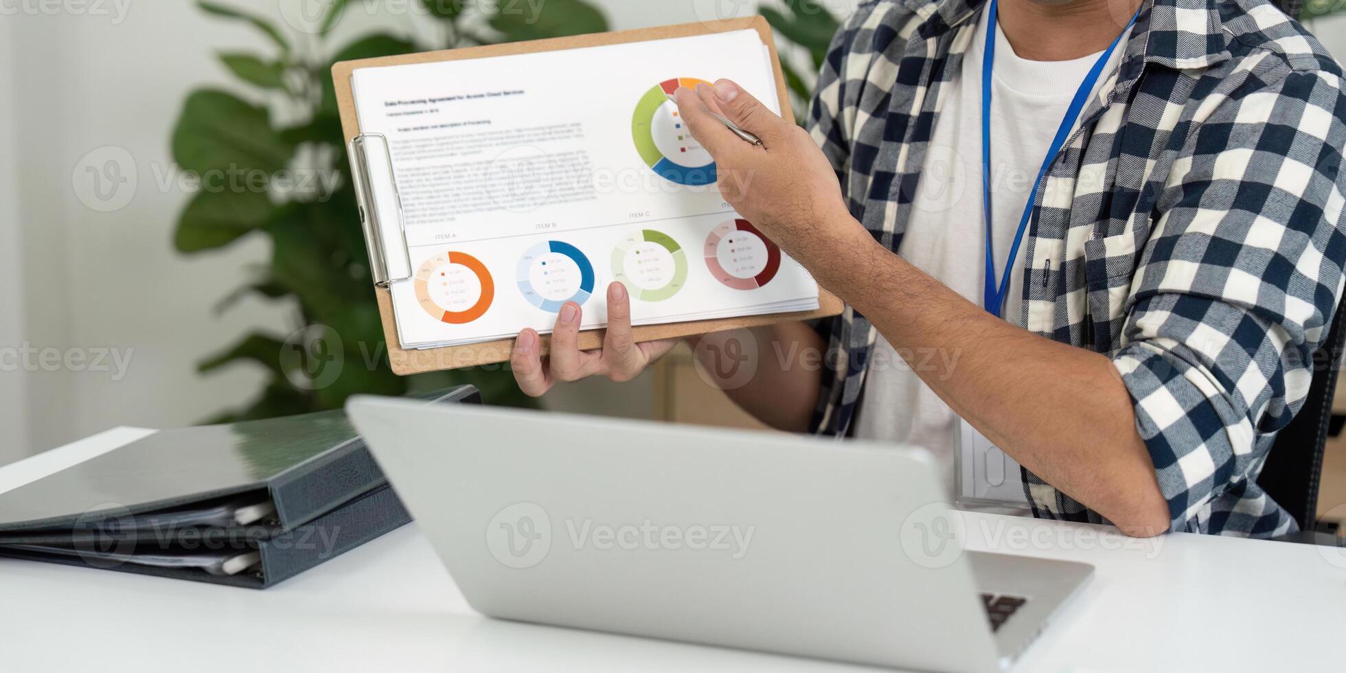 Data Presentation. Young man explaining charts during a business meeting in a home office. photo