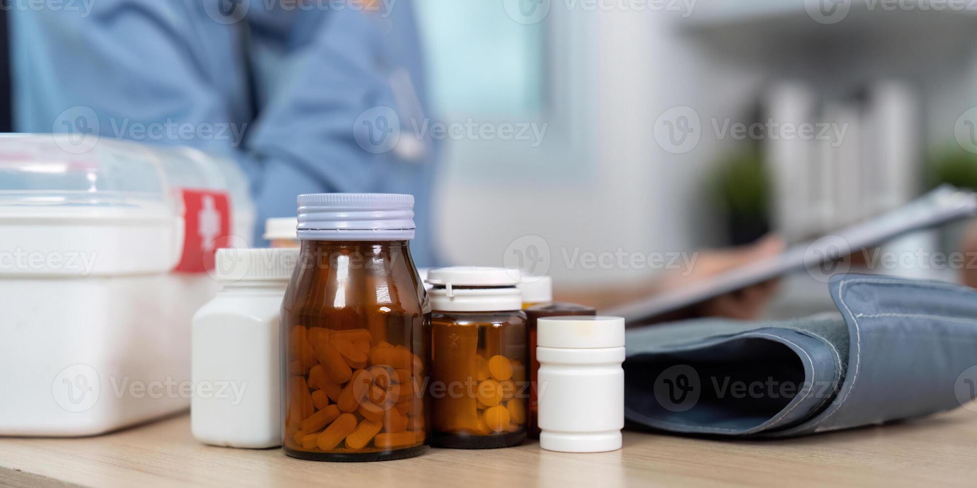 Medication Management. Various medicine bottles displayed during a healthcare consultation. photo