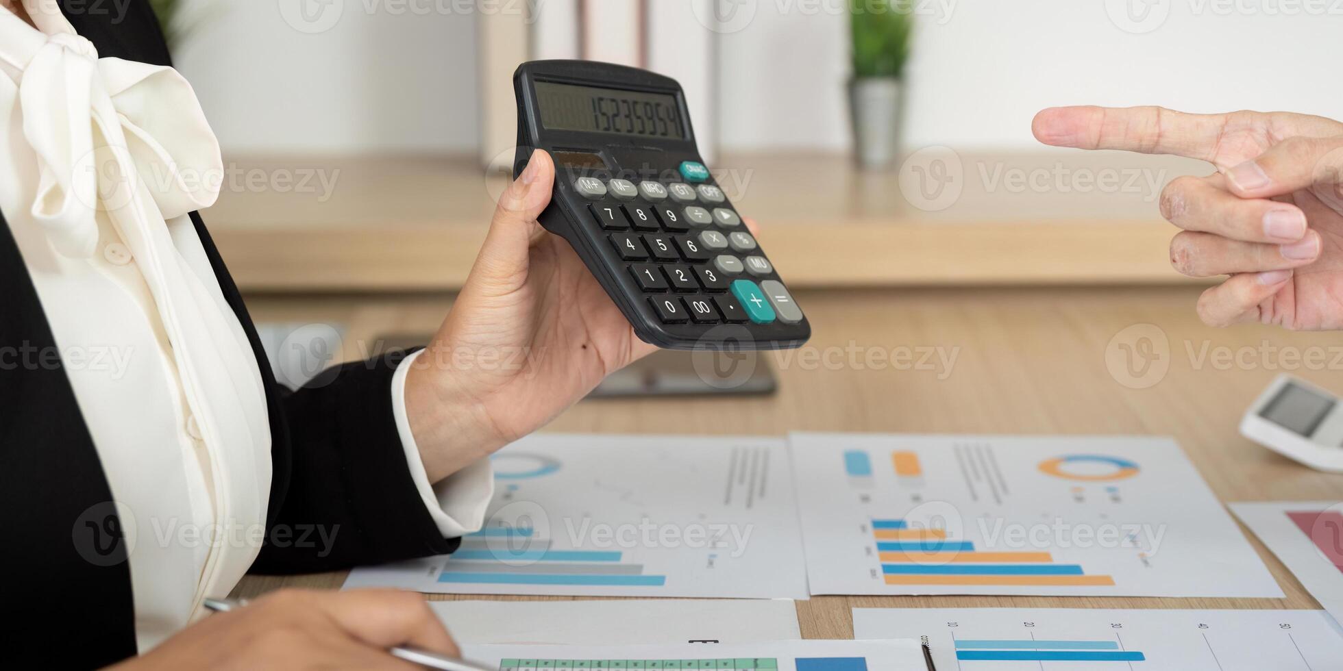 Accounting Consultation with Calculator. Business professional analyzing financial data. photo