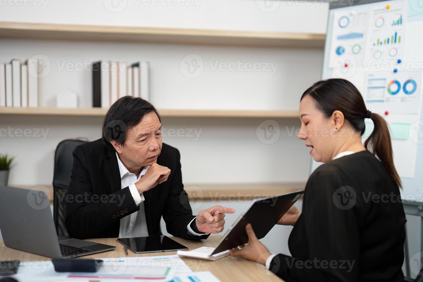 Strategic Business Meeting. Consultant presenting digital reports to a client in a modern office. photo