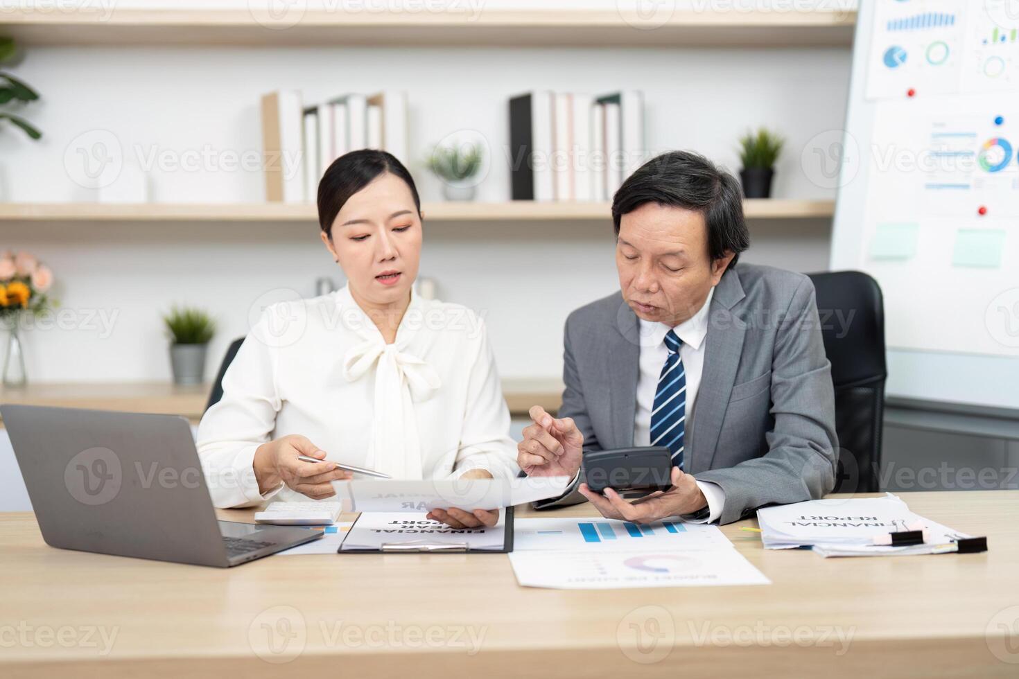Strategic Financial Consultation. Business professionals analyzing reports and data in a modern office. photo