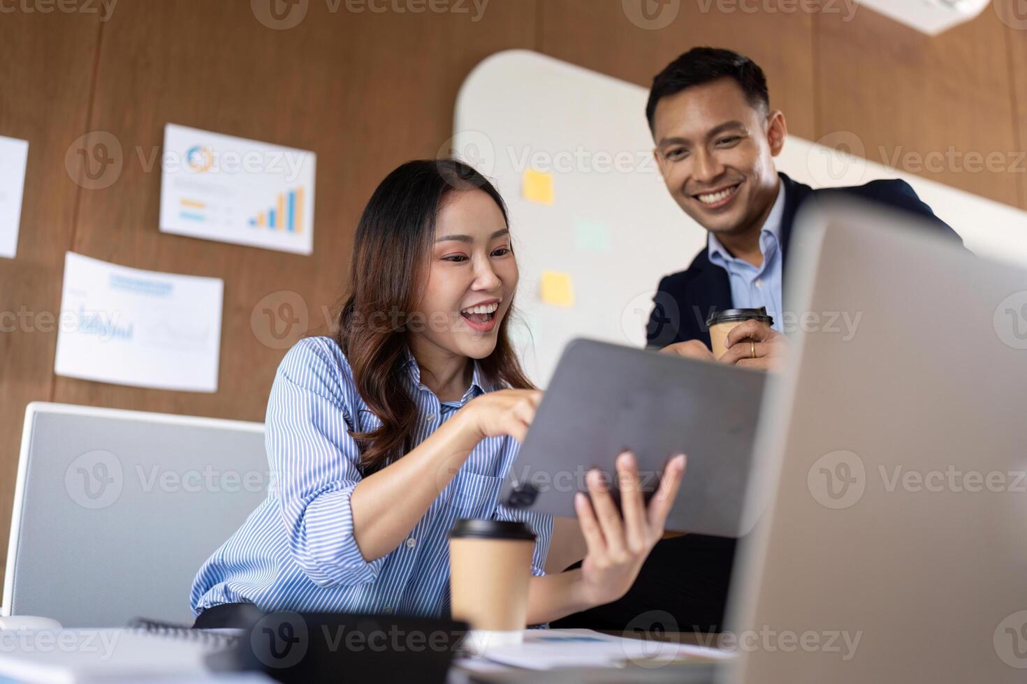Engaged Teamwork. Professionals collaborating on a digital tablet in office. photo
