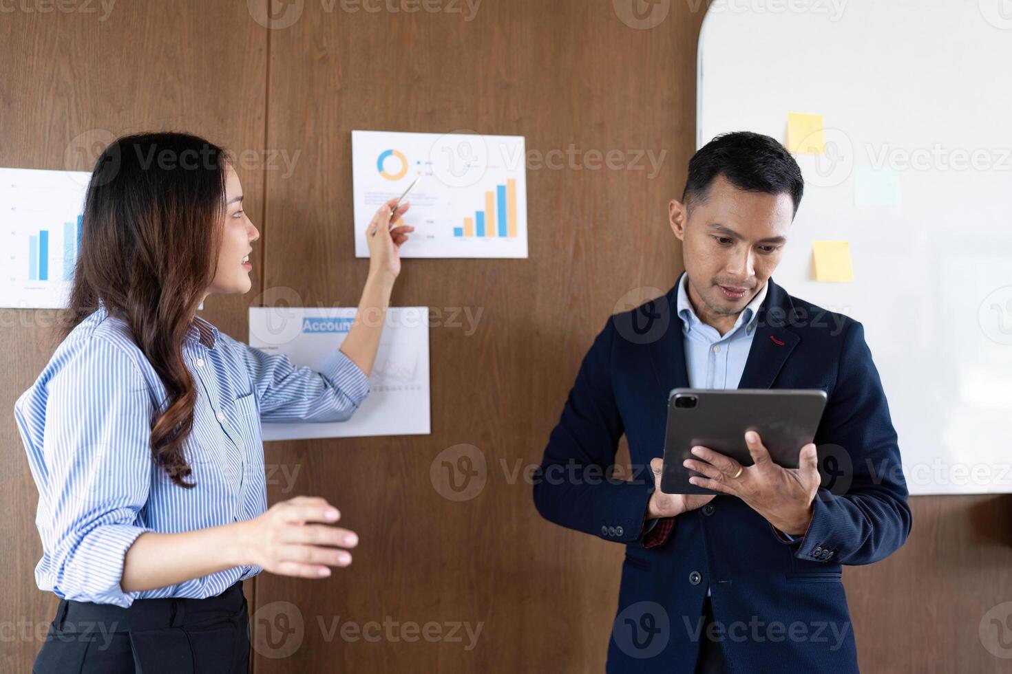 Strategic Planning. Business team discussing data insights on a whiteboard. photo