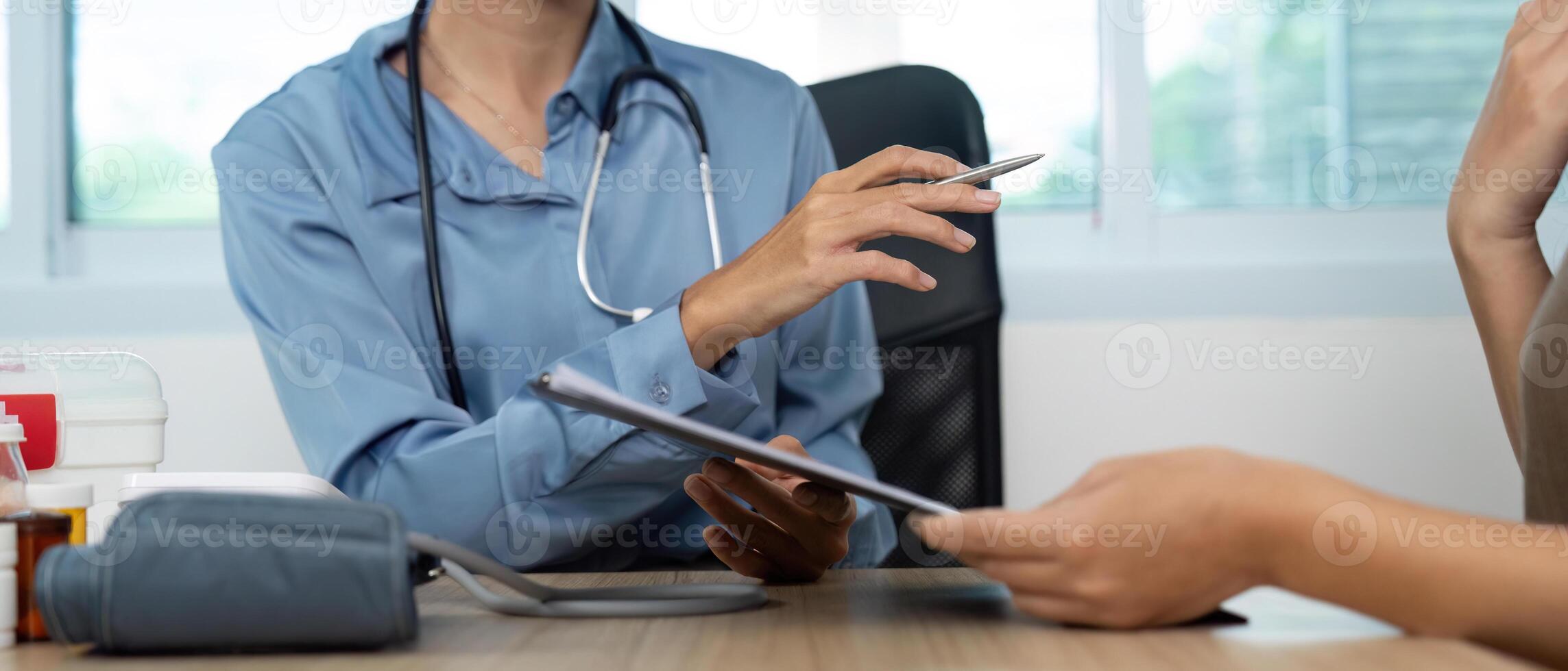 Digital Health Consultation. Doctor explaining treatment options using a tablet. photo
