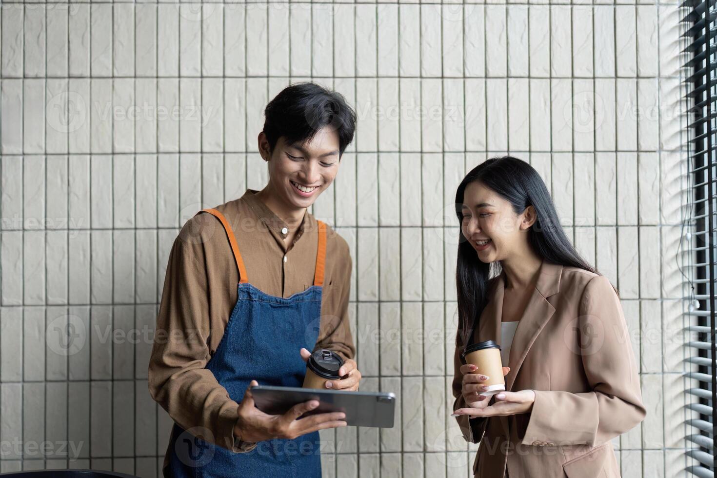 Engaging Team Meeting. Two colleagues sharing insights and discussing ideas over coffee and a tablet. photo
