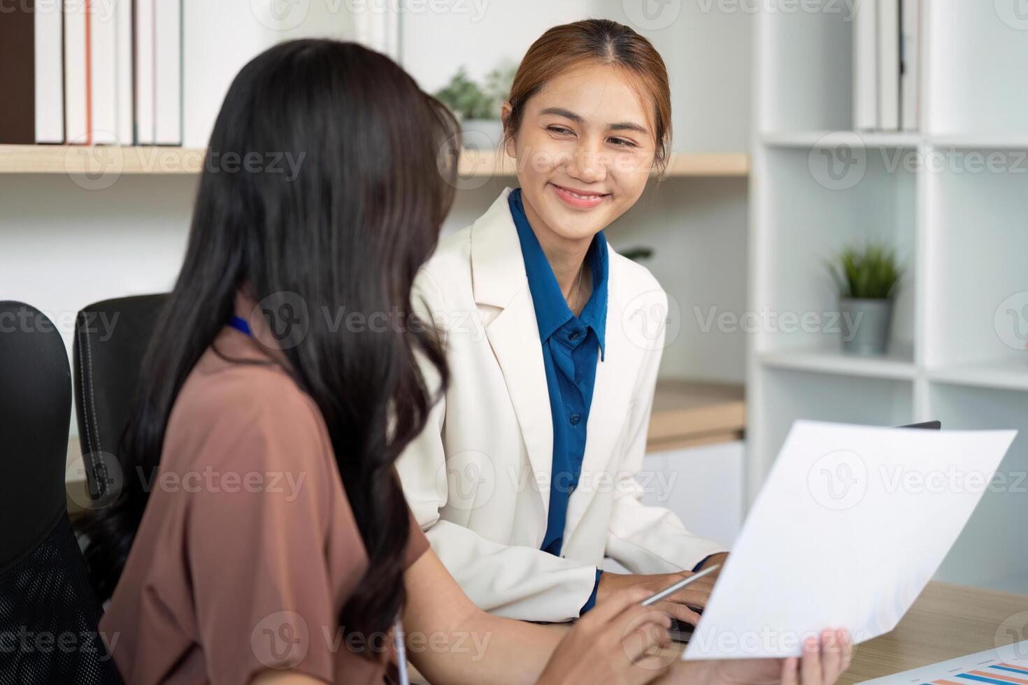 Team Collaboration and Engagement. Smiling professionals discussing financial strategies in an office. photo