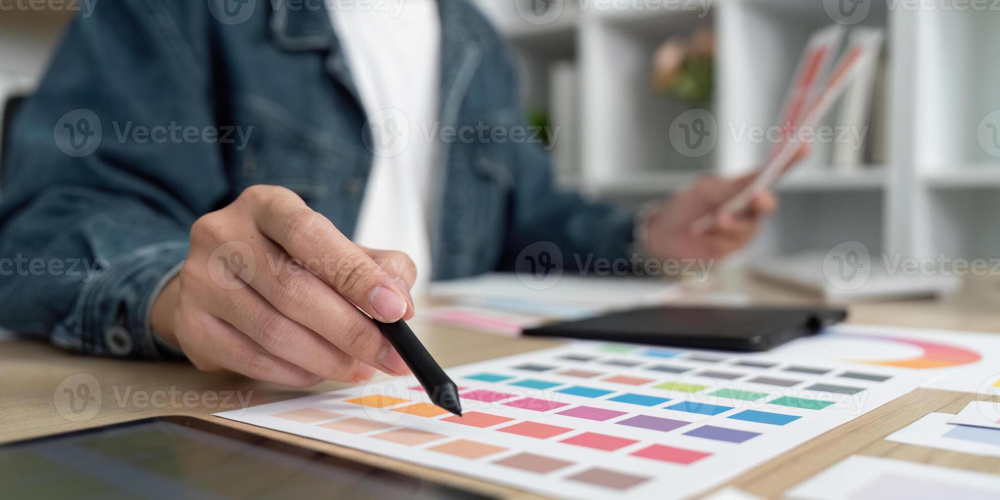Design Focus. Artist Analyzing Color Schemes and Layouts photo
