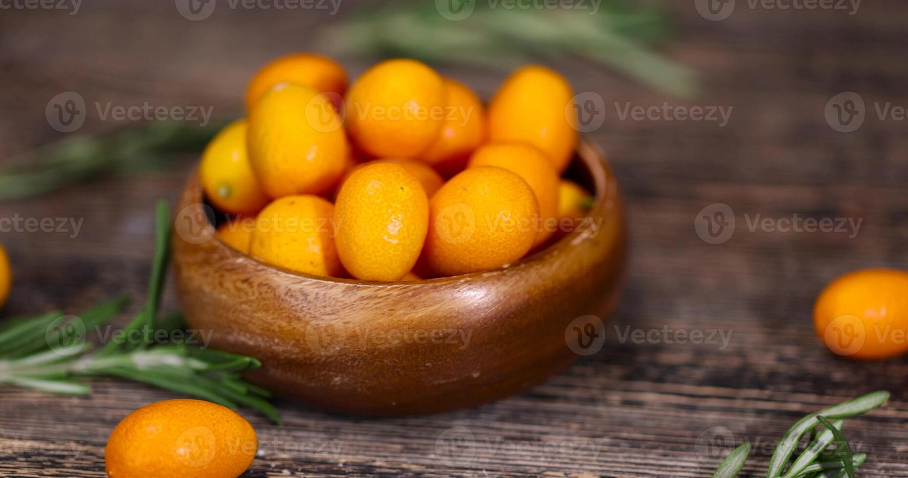 fresh orange kumquat fruits and green spices rosemary photo