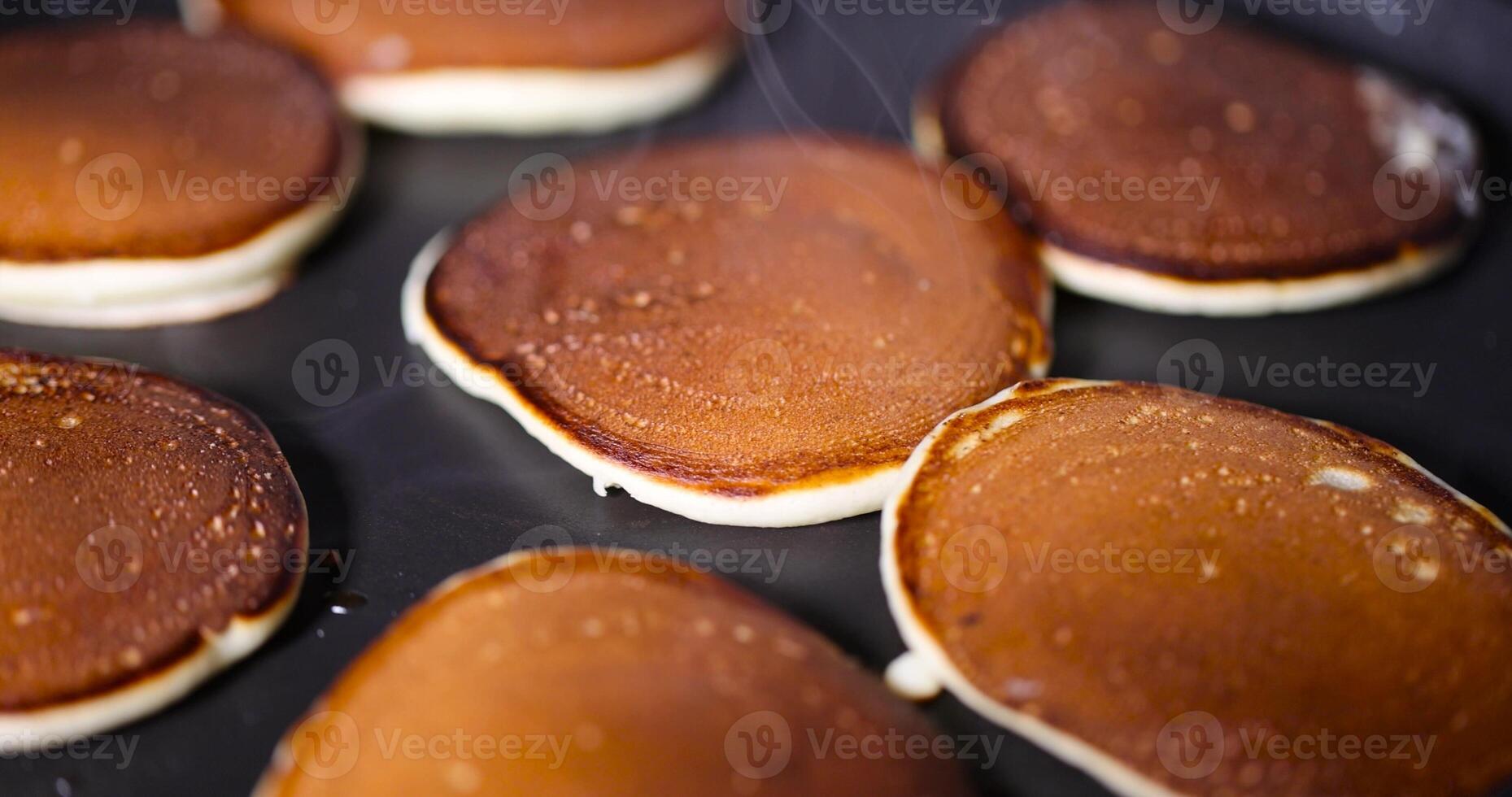 metal pan while cooking pancakes with butter photo